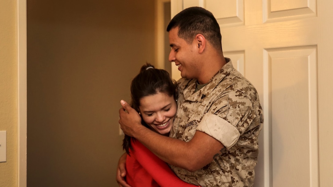 Corporal Alberto Perez III, right, administrative specialist, 15th Marine Expeditionary Unit, holds his wife, Carla Jimenez, as they discuss decorations for their unborn child's room aboard Camp Pendleton, Calif., May 8, 2014. Perez, 22, is from Burbank, Calif. (U.S. Marine Corps photo by Cpl. Emmanuel Ramos/Released)