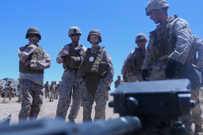 Ryan Forbes, third from left, a 13 year-old native of San Diego, talks with Marines about various weapon systems at Marine Corps Air Ground Combat Center Twentynine Palms May 13, 2014. Forbes was an honorary Marine for a day with Lima Battery, 3rd Battalion, 11th Marine Regiment, and learned about the lifestyles of the Marines. He was accompanied by his parents and brother, and attended training with the battery, participating in drills and eating lunch with a section. Forbes has wanted to join the military for several years and spends time learning what it would take to get through boot camp. He was diagnosed with medulloblastoma, a form of brain cancer in January. His diagnosis and current treatment for medullablastoma hasnt hampered his enthusiasm for the military.