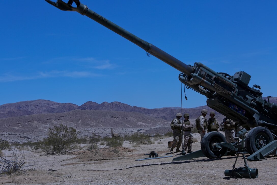 Ryan Forbes, second from left, a 13 year-old native of San Diego, talks with Marines about the M777 lightweight howitzer at Marine Corps Air Ground Combat Center Twentynine Palms May 13, 2014. Forbes was an honorary Marine for a day with Lima Battery, 3rd Battalion, 11th Marine Regiment, and learned about the weapons systems and lifestyles of the Marines. He was accompanied by his parents and brother, and attended training with the battery, participating in drills and eating lunch with a section. Forbes has wanted to join the military for several years and spends time learning about the different branches. He was diagnosed with medulloblastoma, a form of brain cancer in January. His diagnosis and current treatment for medullablastoma hasnt hampered his enthusiasm for the military.