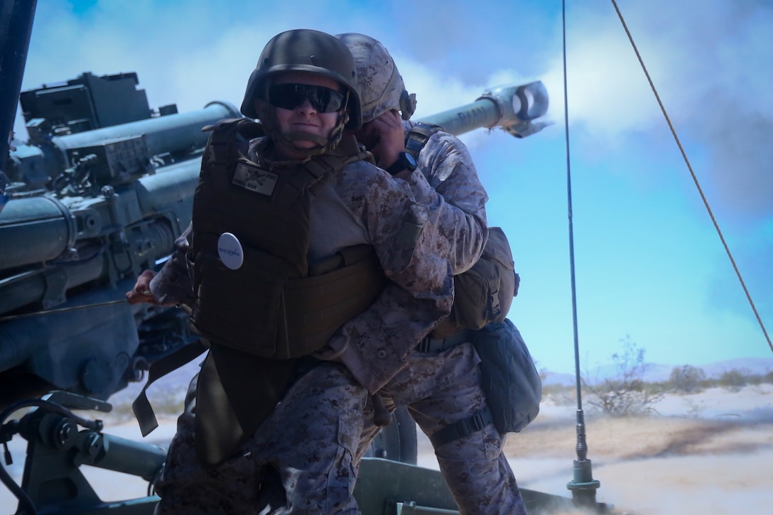 Ryan Forbes, a 13 year-old native of San Diego, pulls a lanyard firing an M777 lightweight howitzer with Marines of Lima Battery, 3rd Battalion, 11th Marine Regiment, at Marine Corps Air Ground Combat Center Twentynine Palms May 13, 2014. Forbes was an honorary Marine for a day with the battery and learned about the lifestyles of the Marines. He was accompanied by his parents and brother, and attended training with the battery, learning how to set up and take down an M777 howitzer and eating lunch with a section. He was diagnosed with medulloblastoma, a form of brain cancer in January but his diagnosis and current treatment hasn't hampered his enthusiasm for the military.