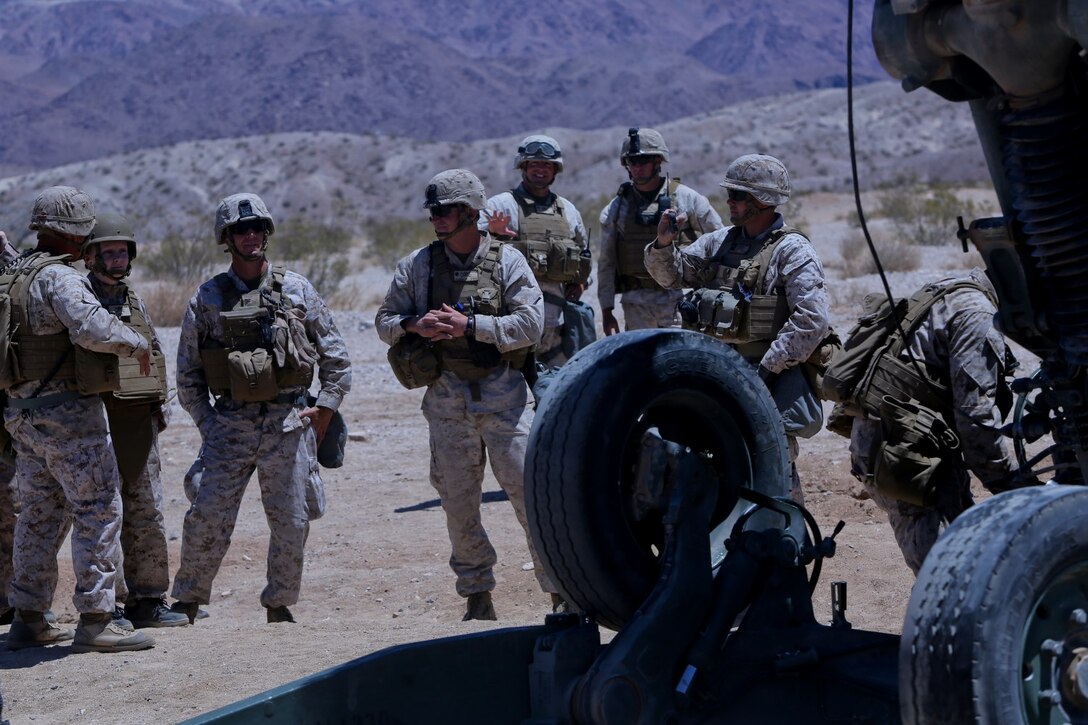 Ryan Forbes, second from left, a 13 year-old native of San Diego, talks with Marines about the M777 lightweight howitzer  at Marine Corps Air Ground Combat Center Twentynine Palms May 13, 2014. Forbes was an honorary Marine for a day with Lima Battery, 3rd Battalion, 11th Marine Regiment and learned about the weapon systems and lifestyles of the Marines. He was accompanied by his parents and brother, and attended training with the battery, participating in drills and eating lunch with a section. Forbes has wanted to join the military for several years and spends time learning about the different branches. He was diagnosed with medulloblastoma, a form of brain cancer in January. His diagnosis and current treatment for medullablastoma hasnt hampered his enthusiasm for the military.