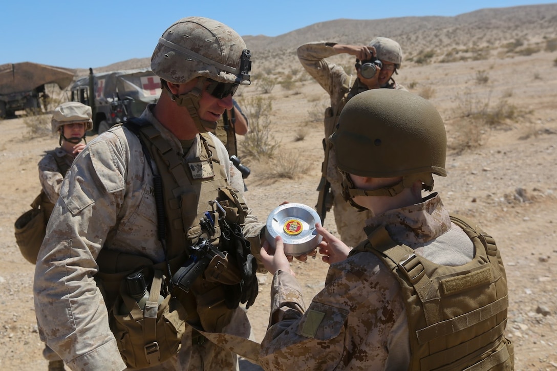 Ryan Forbes, a 13 year-old native of San Diego, receives a gift from Lt. Col. Charlie Von Bergen, commanding officer of 3rd Battalion, 11th Marine Regiment, at Marine Corps Air Ground Combat Center Twentynine Palms May 13, 2014. Forbes was an honorary Marine for a day with the battery and learned about the lifestyles of the Marines. He was accompanied by his parents and brother, and attended training with the battery, learning how to set up and take down an M777 lightweight howitzer and eating lunch with a section. He was diagnosed with medulloblastoma, a form of brain cancer in January but his diagnosis and current treatment hasnt hampered his enthusiasm for the military.