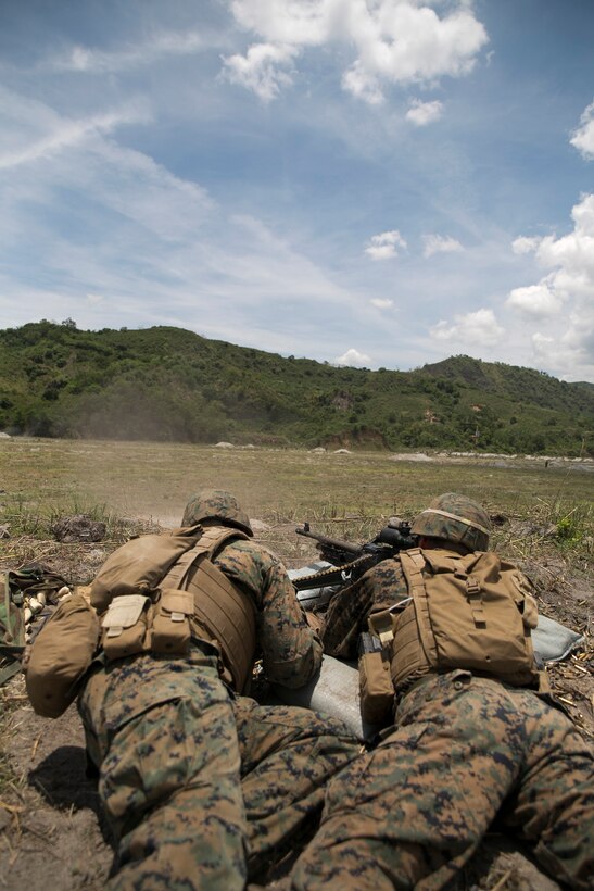 Lance Cpl. John M. Fernandez, left, and Lance Cpl. Christian Cain-Echeandia, right, provide supporting fire for Philippine Marines May 9 at Crow Valley, Philippines as part of Balikatan 2014. The Philippine Marines were conducting squad attacks on the range below, working in conjunction with the machine gunners perched above. Balikatan is a Philippine term meaning “shoulder-to-shoulder,” which encompasses the spirit of the bilateral exercise. Fernandez and Cain-Echeandia are machine gunners with 1st Battalion, 8th Marine Regiment, currently assigned to 4th Battalion, 12th Marine Regiment, 3rd Marine Division, III Marine Expeditionary Force.