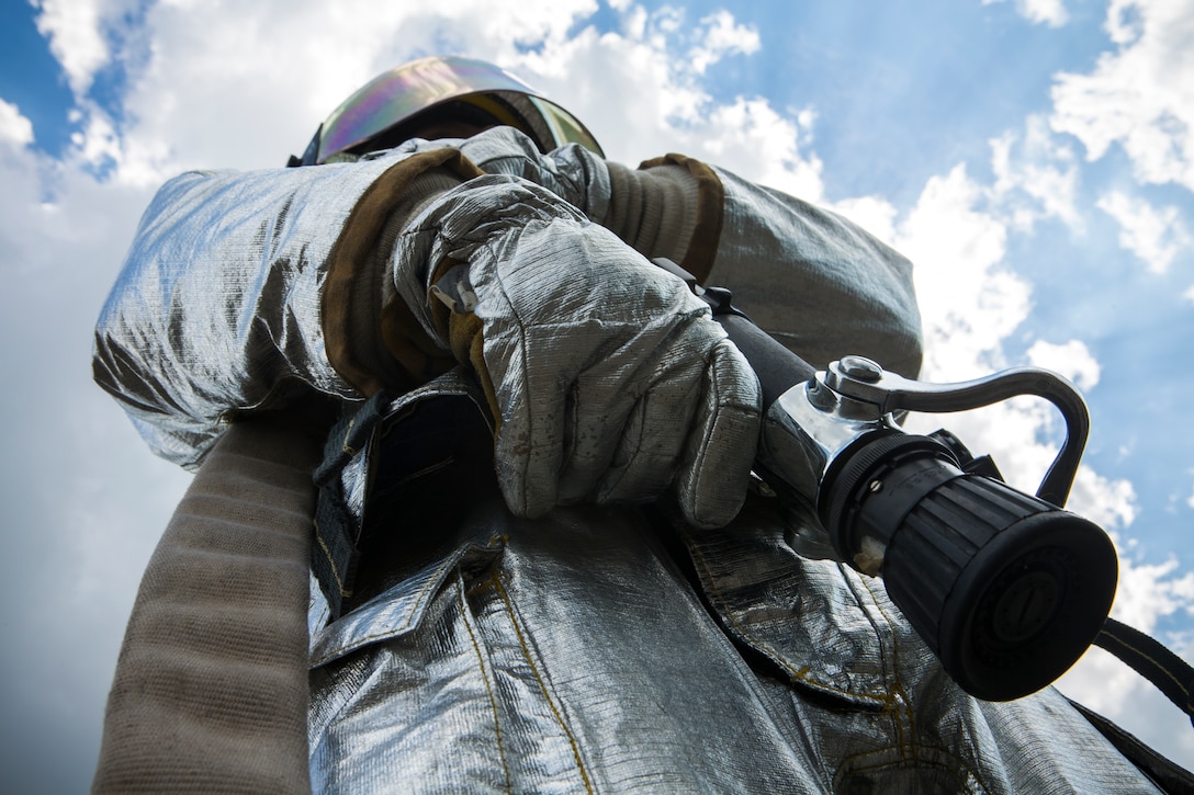 Lance Cpl. Cody A. Gage, an aircraft rescue firefighting specialist, with Marine Wing Support Squadron 172, Marine Aircraft Group 36, 1st Marine Air Wing, stationed at Camp Foster, Okinawa, Japan, stands ready in full gear during a C-130 fire and rescue drill for Balikatan 2014 at Clark Air Base, Mabalacat, Republic of the Philippines, May 12, 2014. This year marks the 30th iteration of Balikatan, which is an annual Republic of the Philippines-U.S. military bilateral training exercise.