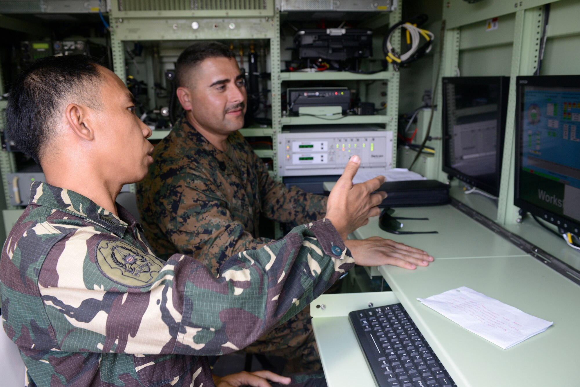 Philippine Air Force Tech. Sgt. Samson Nagasao and U.S. Marine Corps Gunnery Sgt. Thomas Reyes analyze and disseminate weather data inside a mobile meteorology operations center during Balikatan May 8, 2014, at Clark Air Field, Philippines. In its 30th year, Balikatan is an annual training exercise that strengthens the interoperability between the armed forces of the Philippines and U.S. military in their commitment to regional security and stability, humanitarian assistance and disaster relief. Nagasao is a weather technician with 900th Weather Group, Philippine Air Force. Reyes is a meteorology and oceanography chief with Marine Air Traffic Control Squadron 4, Marine Air Control Group 18, 1st Marine Aircraft Wing. (U.S. Air Force photo by Tech. Sgt. Raymond Mills/Released)