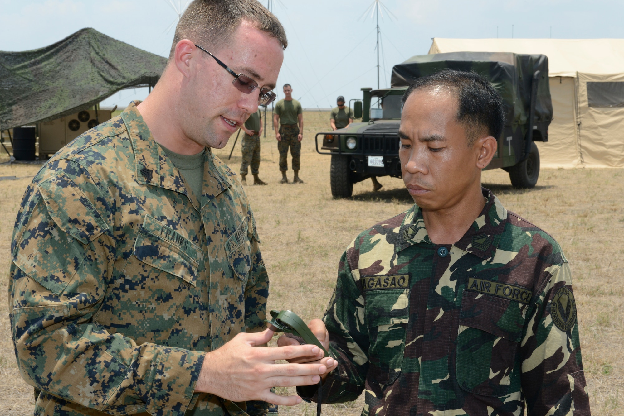 Philippine Air Force Tech. Sgt. Samson Nagasao, right, and U.S. Marine Corps Sgt. Christopher Franks discuss the Kestrel handheld weather sensor during Balikatan May 8, 2014, at Clark Air Field, Philippines. By exchanging information and ideas, the Philippine Air Force and U.S. Marines strengthen their partnership during this bilateral military exercise. In its 30th year, Balikatan is an annual training exercise that strengthens the interoperability between the armed forces of the Philippines and U.S. military in their commitment to regional security and stability, humanitarian assistance and disaster relief. Nagasao is a weather technician with 900th Weather Group, Philippine Air Force. Franks is a meteorology and oceanography analyst forecaster with Marine Air Traffic Control Squadron 4, Marine Air Control Group 18, 1st Marine Aircraft Wing. (U.S. Air Force photo by Tech Sgt. Raymond Mills/Released)