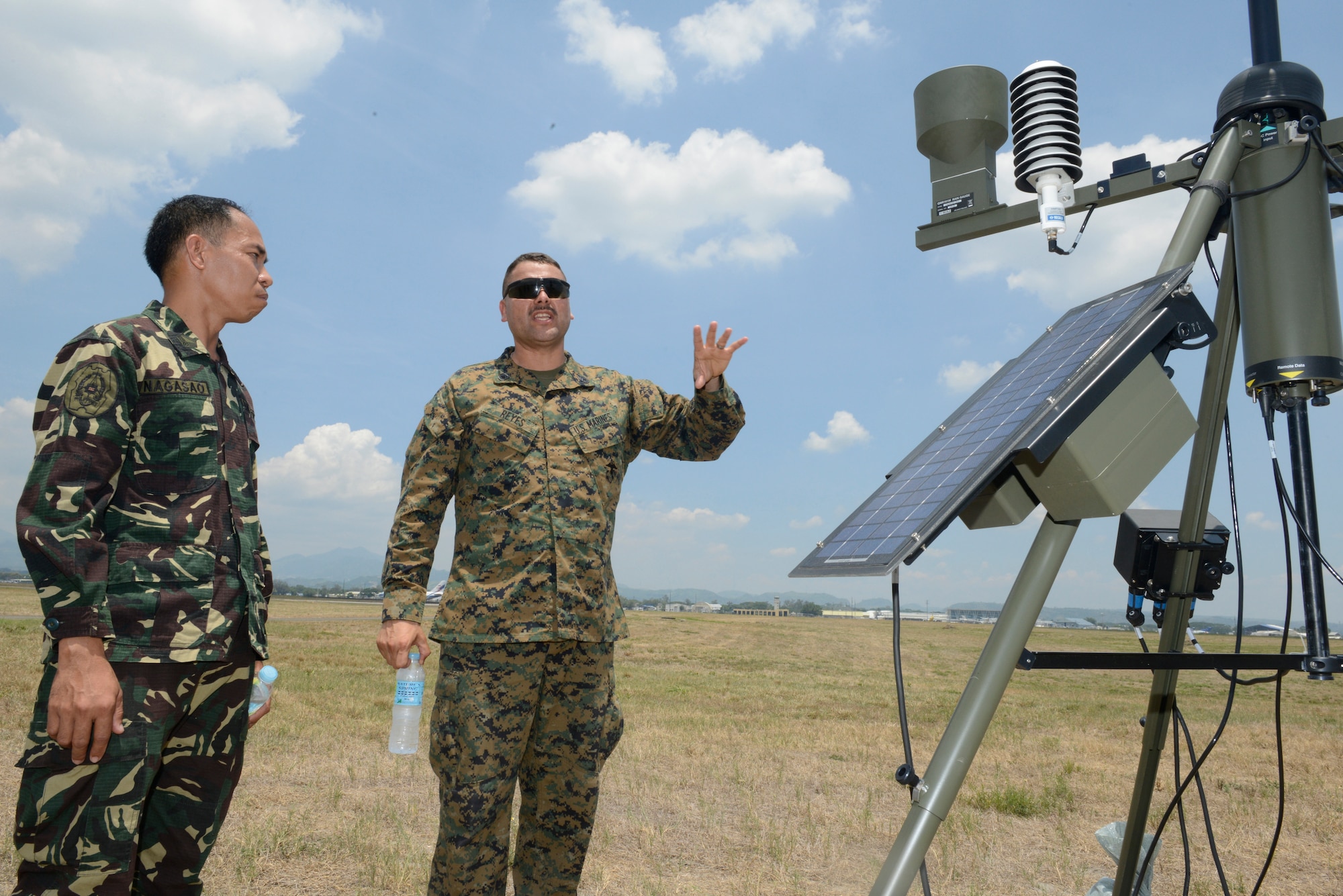 Philippine Air Force Tech. Sgt. Samson Nagasao, left, conducts a subject matter expert exchange about the Local Sensor Subsystem with U.S. Marine Gunnery Sgt. Thomas Reyes during Balikatan May 8, 2014, at Clark Air Field, Philippines. The LSS is a primary meteorological data collection asset used to acquire timely and accurate information about the weather. In its 30th year, Balikatan is an annual training exercise that strengthens the interoperability between the armed forces of the Philippines and U.S. military in their commitment to regional security and stability, humanitarian assistance and disaster relief. Nagasao is a weather technician with 900th Weather Group, Philippine Air Force. Reyes is a meteorology and oceanography chief with Marine Air Traffic Control Squadron 4, Marine Air Control Group 18, 1st Marine Aircraft Wing. (U.S. Air Force photo by Tech. Sgt. Raymond Mills/Released)