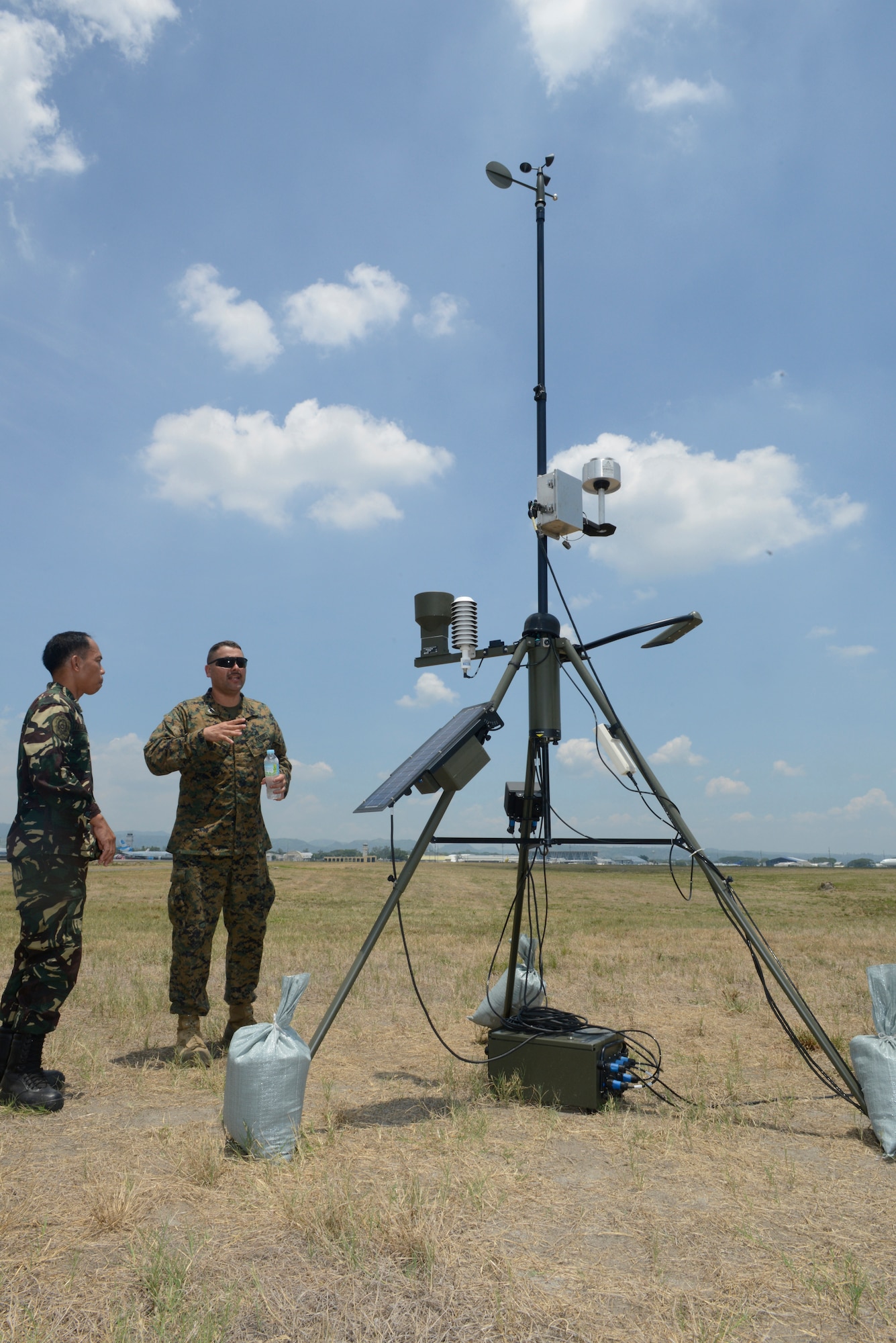 Philippine Air Force Tech. Sgt. Samson Nagasao, left, and U.S. Marine Corps Gunnery Sgt. Thomas Reyes exchange information about a Local Sensor Subsystem during Balikatan May 8, 2014, at Clark Air Field, Philippines. The LSS is a primary meteorological data collection asset used to acquire timely and accurate information about the weather. In its 30th year, Balikatan is an annual training exercise that strengthens the interoperability between the armed forces of the Philippines and U.S. military in their commitment to regional security and stability, humanitarian assistance and disaster relief. Nagasao is a weather technician with 900th Weather Group, Philippine Air Force. Reyes is a meteorology and oceanography chief with Marine Air Traffic Control Squadron 4, Marine Air Control Group 18, 1st Marine Aircraft Wing. (U.S. Air Force photo by Tech. Sgt. Raymond Mills/Released)