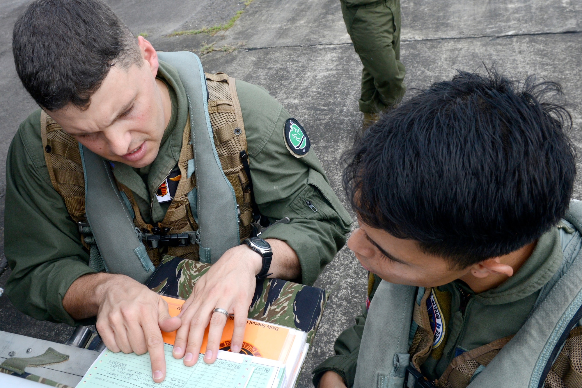 Philippine Air Force Capt. Jose W. Martinez, right, and U.S. Marine Capt. Adam M. Stoll discuss the flight plan prior to a familiarization flight in an F/A-18 Hornet aircraft at Clark Air Field, Philippines, May 9 during Balikatan 2014. This annual training exercise strengthens the interoperability between the Armed Forces of the Philippines and U.S. military in their commitment to regional security and stability, humanitarian assistance and disaster relief. Martinez is a pilot with Philippine Air Force Air Defense Wing. Stoll is an F/A-18 pilot with Marine All Weather Fighter Attack Squadron 224. (U.S. Air Force photo by Tech. Sgt. Raymond Mills/Released)