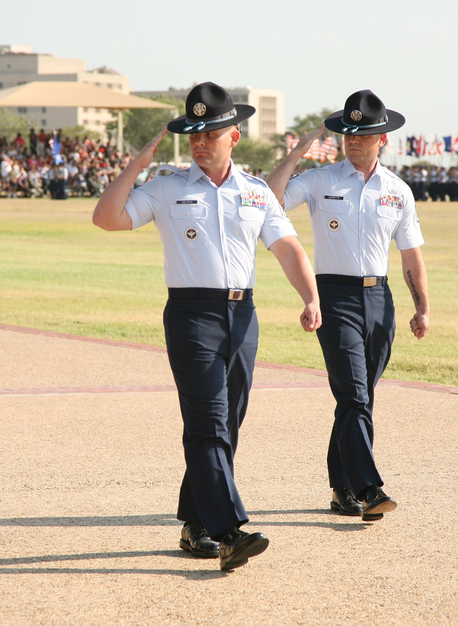 Tech Sgt. Matthew Coltrin, former Air Force Basic Military Training Instructor, (left), performs "eyes right" during his final parade as a basic military training instructor at Lackland Air Force Base, Texas, June 17, 2011. In 2006, Coltrin applied for MTI duty and throughout his years wearing his hat, he received several accolades, including the Excellence in Instruction award at Military Training Instructor School, Non-commissioned Officer of the Year, Military Training Instructor Association President’s Award, and Blue Rope of the Year.  (Courtesy Photo)