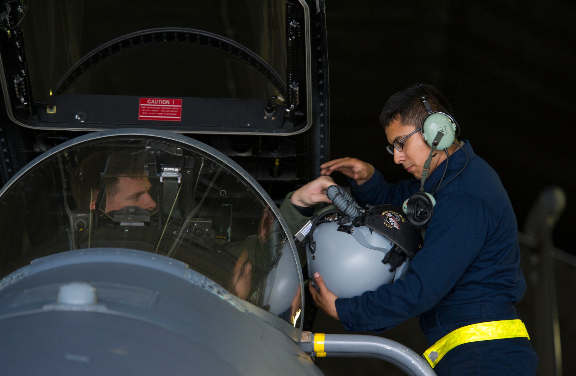 KEFLAVIK, Iceland – Capt. Matt Tanis, 48th Air Expeditionary Group F-15C Eagle pilot, hand his helmet to Airman 1st Class Gumecindo Bravo, 48th AEG crew chief, after preparing an F-15 for short-notice takeoffs at Keflavik Airport, Iceland, May 14, 2014. The pilot and crew chief are certifying to scramble for takeoff so they can perform the mission of protecting Iceland’s airspace while deployed for Icelandic Air Policing. (U.S. Air Force photo/Tech. Sgt. Benjamin Wilson)(Released)