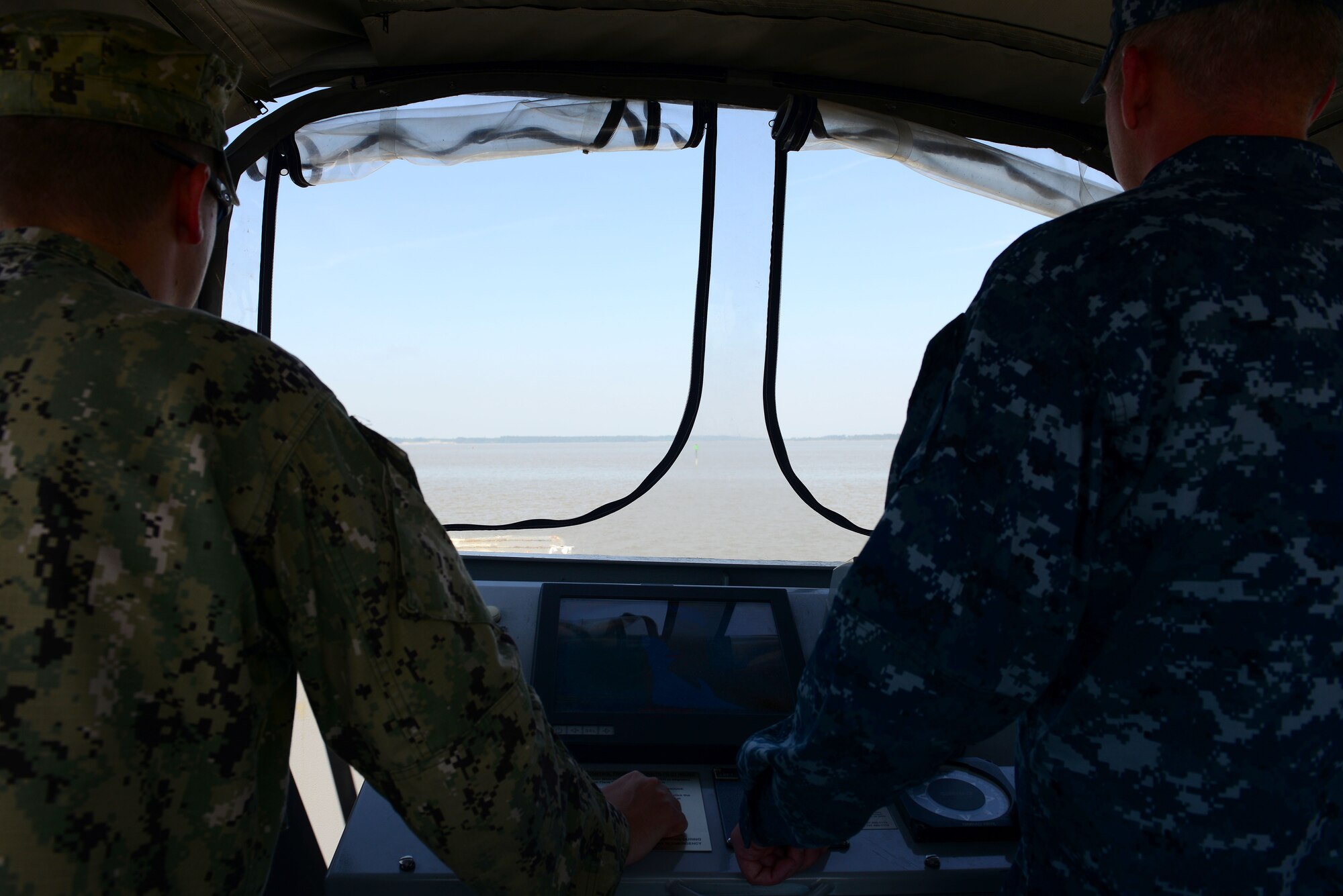 From left, U.S. Navy Chief Petty Officer Brett Curns, chief quartermaster and craft master, assists Chief Petty Officer James Devers, boatswain mate and craft master student, during Craft Master Course training at Fort Eustis, Va., May 12, 2014. Devers took the six-week course in order to become a certified craft master. Curns hails from Wichita, Kan. and Devers hails from Memphis, Tenn. (U.S. Air Force photo by Airman 1st Class Kimberly Nagle/Released)