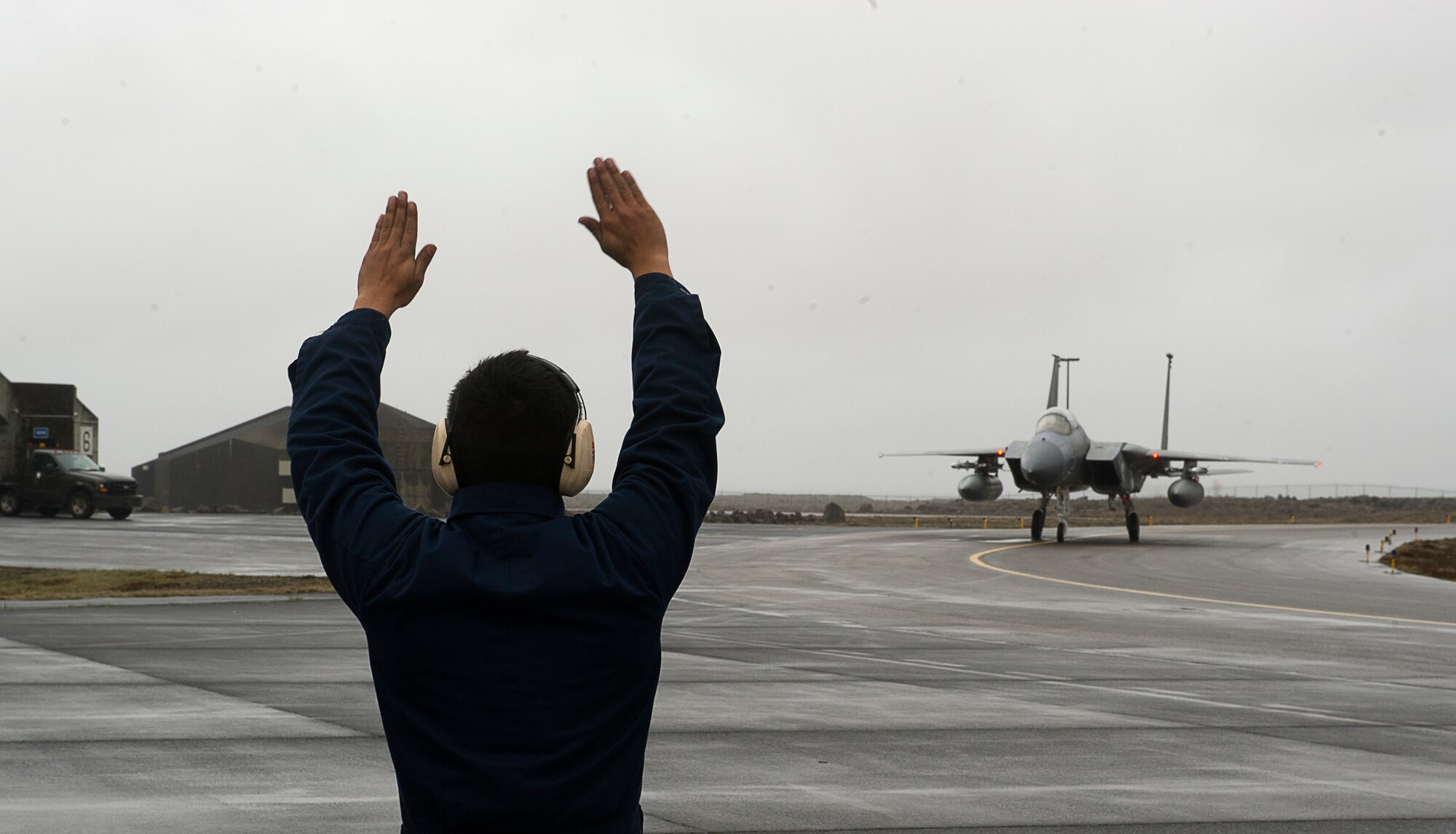 KEFLAVIK, Iceland – Airman 1st Class Gumecindo Bravo, 48th Air Expeditionary Group crew chief, directs Capt. Matt Tanis, 48th AEG pilot, as he taxis his at Keflavik Airport, Iceland, May 14, 2014. The pilot and crew chief are certifying to scramble for takeoff so they can perform the mission of protecting Iceland’s airspace while deployed for Icelandic Air Policing. (U.S. Air Force photo/Tech. Sgt. Benjamin Wilson)(Released)