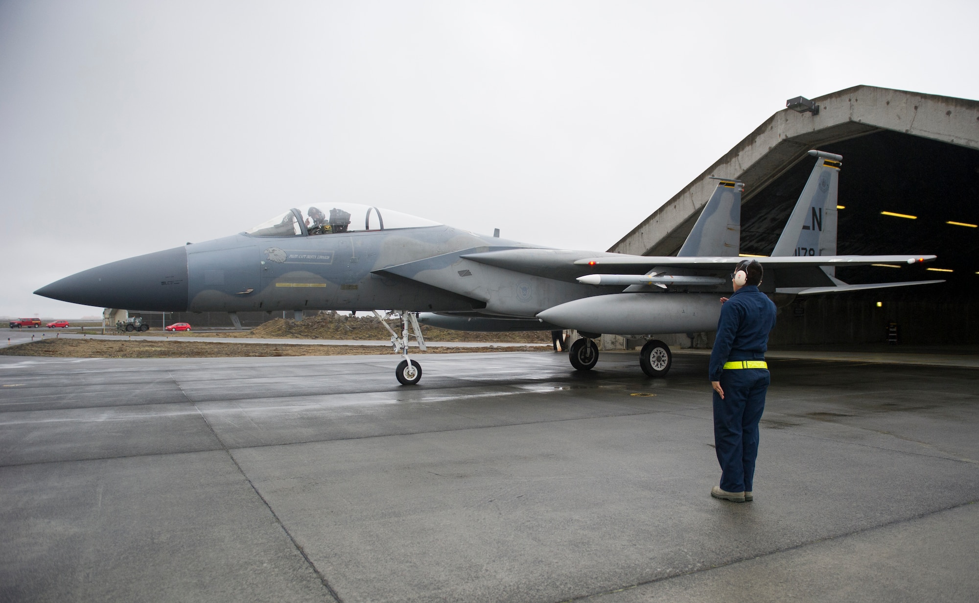 KEFLAVIK, Iceland – Airman 1st Class Gumecindo Bravo, 48th Air Expeditionary Group crew chief, salutes Capt. Matt Tanis, 48th AEG pilot, as he taxis his at Keflavik Airport, Iceland, May 14, 2014. The pilot and crew chief are certifying to scramble for takeoff so they can perform the mission of protecting Iceland’s airspace while deployed for Icelandic Air Policing. (U.S. Air Force photo/Tech. Sgt. Benjamin Wilson)(Released)