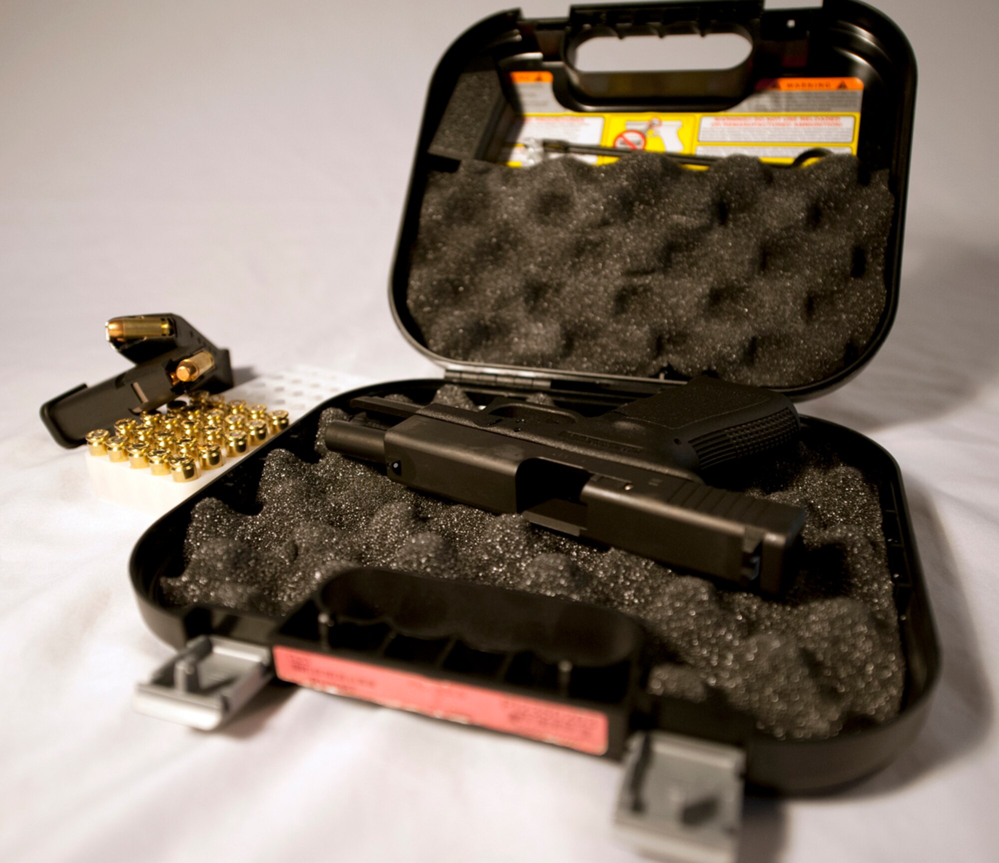 A .40-caliber pistol lies in a case unloaded on Joint Base Elmendorf-Richardson, Alaska, May 13, 2014. Weapons must be registered prior to entering the base. Bringing a loaded and unregistered weapon on base violates JBER Instruction 31-107 and becomes a threat to JBER Security Forces. (U.S. Air Force photo/Airman 1st Class Tammie Ramsouer)