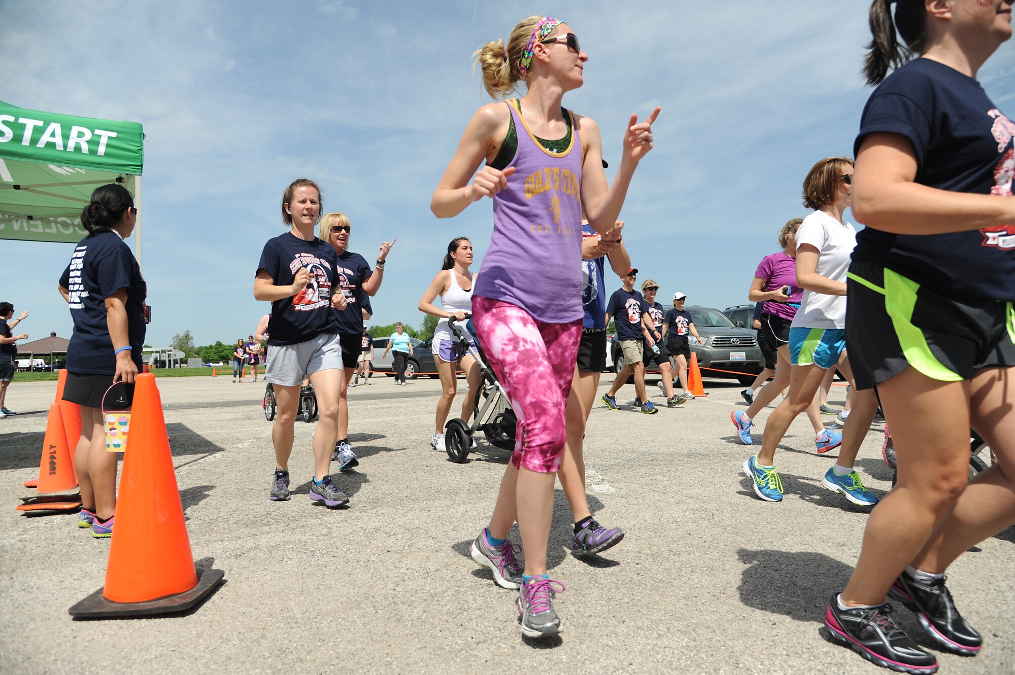 To promote Military Spouse Appreciation Day, and to give thanks to the spouses on Scott Air Force Base, the spouses held a 5K run for all who have access to the base May 9, 2014, Scott AFB, Ill. Participants arrived in teal outfits, capes, and headbands. Some individuals ran with their kids, or even let their kids run. Awards were given to the fastest male and female, and the first kid to cross the finish line. (U.S. Air Force Photo/ Senior Airman Tristin English)