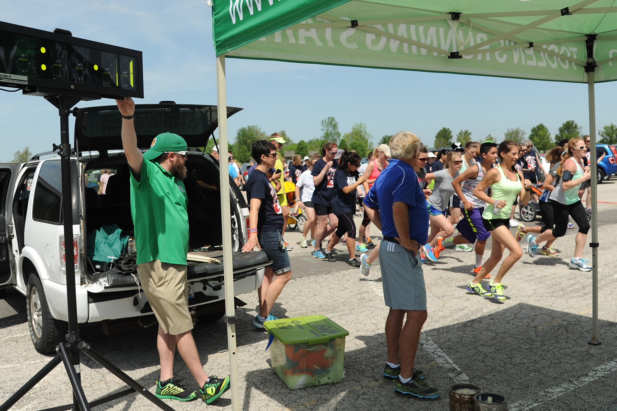 To promote Military Spouse Appreciation Day, and to give thanks to the spouses on Scott Air Force Base, the spouses held a 5K run for all who have access to the base May 9, 2014, Scott AFB, Ill. Participants arrived in teal outfits, capes, and headbands. Some individuals ran with their kids, or even let their kids run. Awards were given to the fastest male and female, and the first kid to cross the finish line. (U.S. Air Force Photo/ Senior Airman Tristin English)