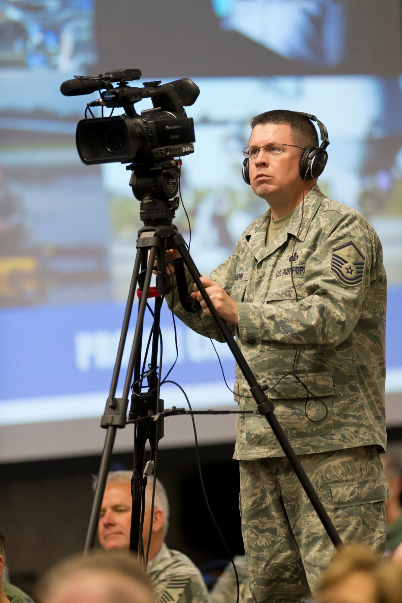Master Sgt. Matthew Hilborn, a broadcaster assigned to the National Guard Bureau Public Affairs, documents eventds during the during the 2014 Executive Safety Summit at Volk Field Combat Readiness Training Center, Wis., May 14, 2014. This year’s conference theme: “Leaders: Don’t Let Your Guard Down”, covers a wide range of topics including safety, resilience, diversity and mishap prevention. (U.S. Air National Guard Photo by Master Sgt. Marvin Preston/ Released)