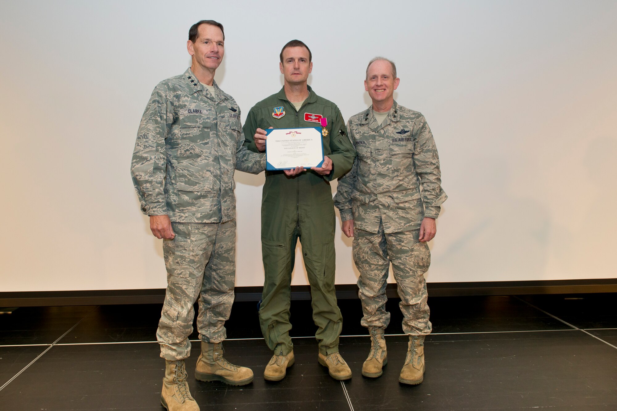 Lt. Gen. Stanley E. Clarke III, the director of the Air National Guard (left) and Maj. Gen. Donald P. Dunbar (right), Wisconsin adjutant general presents the Legion of Merit to Col. Jeffrey J. Wiegand, commander of the 115th Fighter Wing, Wisconsin ANG during the 2014 Executive Safety Summit at Volk Field Combat Readiness Training Center, Wis., May 14, 2014. This year’s conference theme: “Leaders: Don’t Let Your Guard Down”, covers a wide range of topics including safety, resilience, diversity and mishap prevention. The Legion of Merit is awarded by direction of the President for exceptionally meritorious conduct in the performance of outstanding services to the United States. (U.S. Air National Guard Photo by Master Sgt. Marvin Preston/ Released)