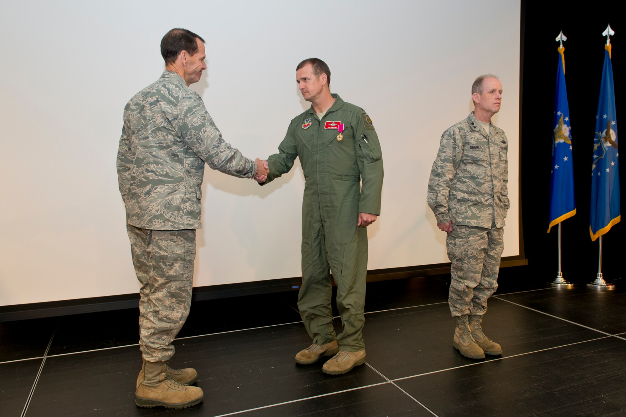 Lt. Gen. Stanley E. Clarke III, the director of the Air National Guard (left) and Maj. Gen. Donald P. Dunbar (right), Wisconsin adjutant general presents the Legion of Merit to Col. Jeffrey J. Wiegand, commander of the 115th Fighter Wing, Wisconsin ANG during the 2014 Executive Safety Summit at Volk Field Combat Readiness Training Center, Wis., May 14, 2014. This year’s conference theme: “Leaders: Don’t Let Your Guard Down”, covers a wide range of topics including safety, resilience, diversity and mishap prevention. The Legion of Merit is awarded by direction of the President for exceptionally meritorious conduct in the performance of outstanding services to the United States. (U.S. Air National Guard Photo by Master Sgt. Marvin Preston/ Released)