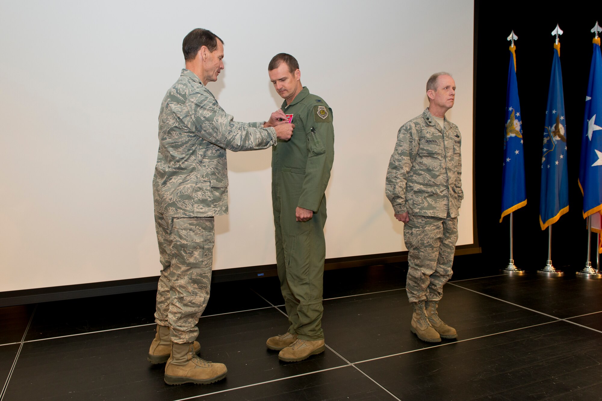 Lt. Gen. Stanley E. Clarke III, the director of the Air National Guard (left) and Maj. Gen. Donald P. Dunbar (right), Wisconsin adjutant general presents the Legion of Merit to Col. Jeffrey J. Wiegand, commander of the 115th Fighter Wing, Wisconsin ANG during the 2014 Executive Safety Summit at Volk Field Combat Readiness Training Center, Wis., May 14, 2014. This year’s conference theme: “Leaders: Don’t Let Your Guard Down”, covers a wide range of topics including safety, resilience, diversity and mishap prevention. The Legion of Merit is awarded by direction of the President for exceptionally meritorious conduct in the performance of outstanding services to the United States. (U.S. Air National Guard Photo by Master Sgt. Marvin Preston/ Released)