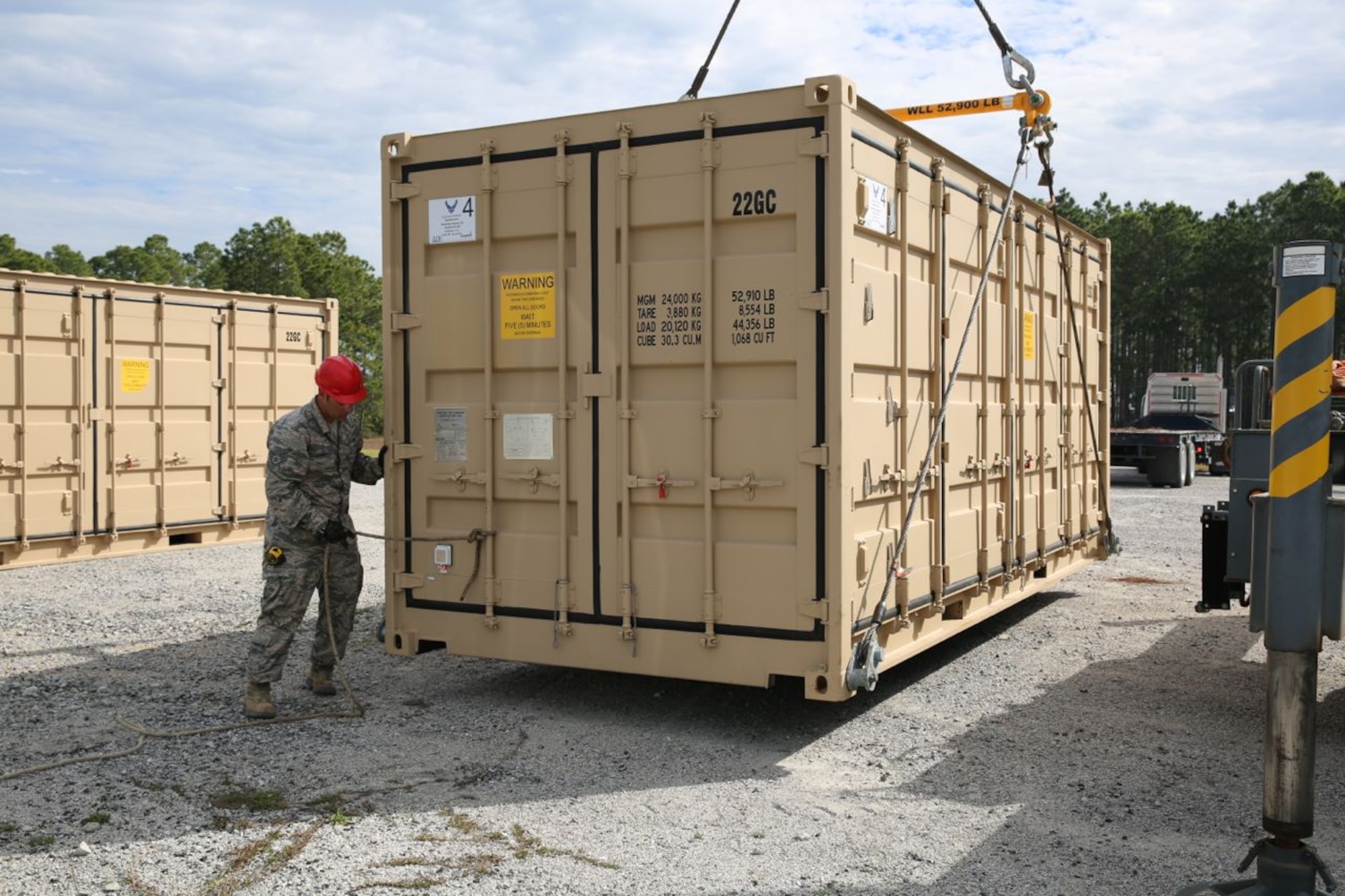 Staff Sgt. David Curry, Detachment 1, 823rd RED HORSE Squadron, directs placement of one of five containers that make up the sustainment pavement repair kit, or SuPR kit, at the Silver Flag exercise site at Tyndall Air Force Base, Fla., on March 11, 2014. The kit contains more than 350 types of items condensed into five 20-foot shipping containers and has the equipment, tools and materials for Air Force pavement and equipment specialists to repair deployed airfields. The kit is now part of Air Force civil engineer contingency training at locations like Silver Flag. (U.S. Air Force photo/Eddie Green)