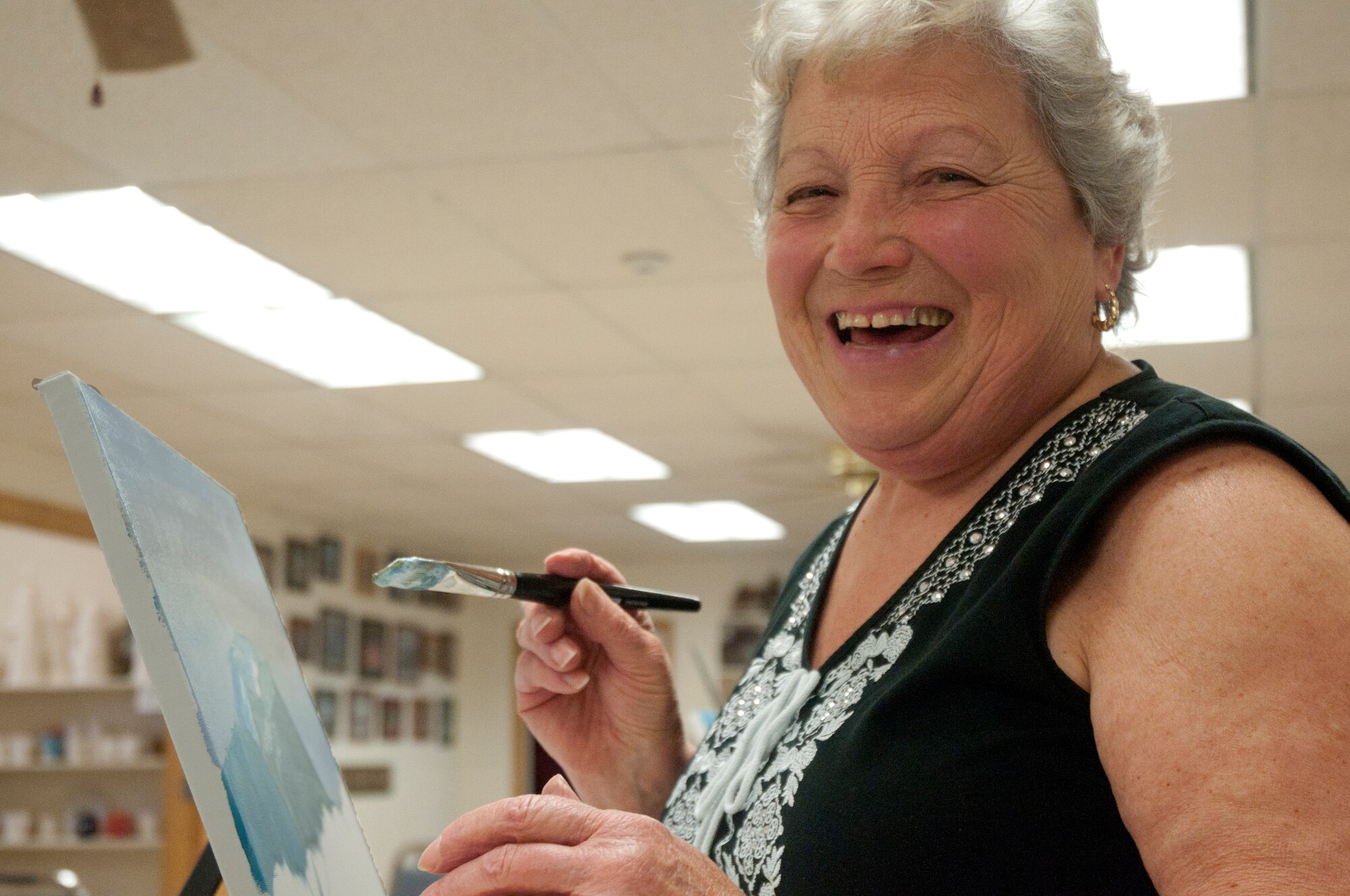 Lina Barajas, wife of a retired Master Sgt. Joe Barajas, participates in an oil painting class May 13 in the Arts and Crafts Center. (U.S. Air Force photo by Airman Malcolm Mayfield)
