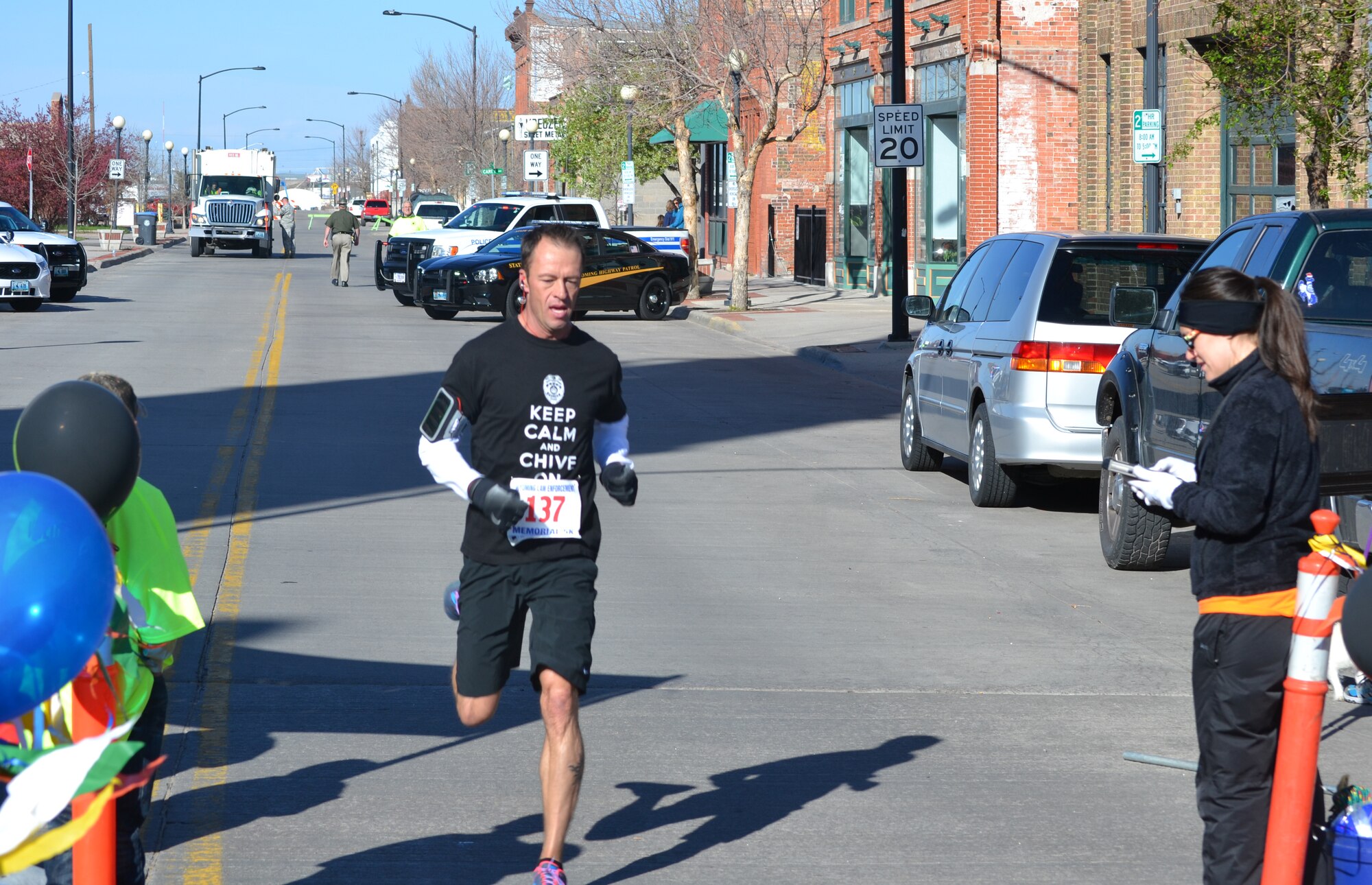 Tech. Sgt. Jamie Lund, 90th Security Support Squadron training instructor, races toward the finish line in downtown Cheyenne, Wyo., during the 2014 Wyoming Law Enforcement Memorial 5K. Lund finished the race in 19 minutes, 41 seconds, placing first in the 30 to 39 age group and third place overall. (Courtesy photo by Jason Pryor)