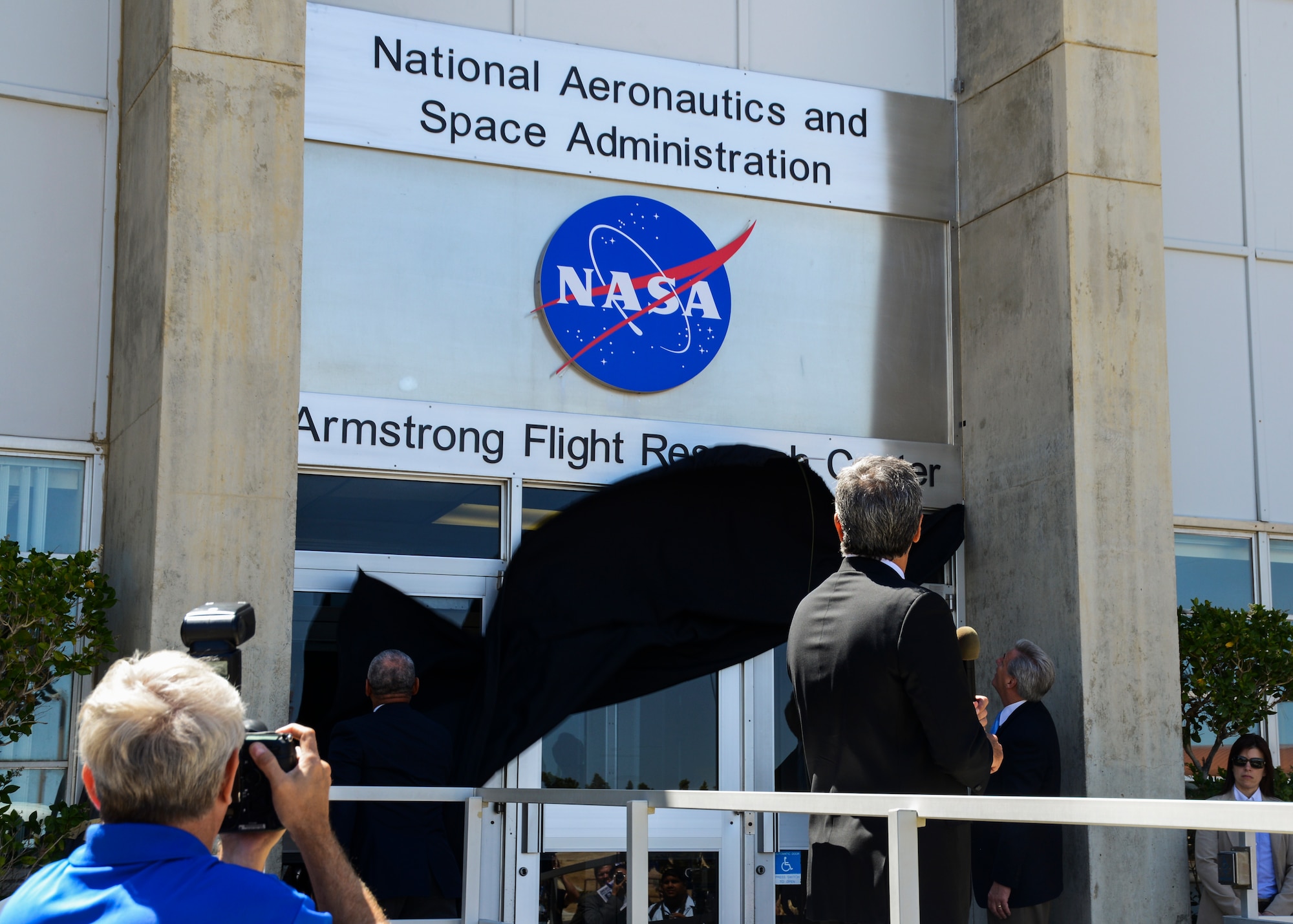 Following a NASA F-18 flyover by tail number 850, the cloth is dropped to reveal the new Building 4800 sign. (U.S. Air Force photo by Rebecca Amber)