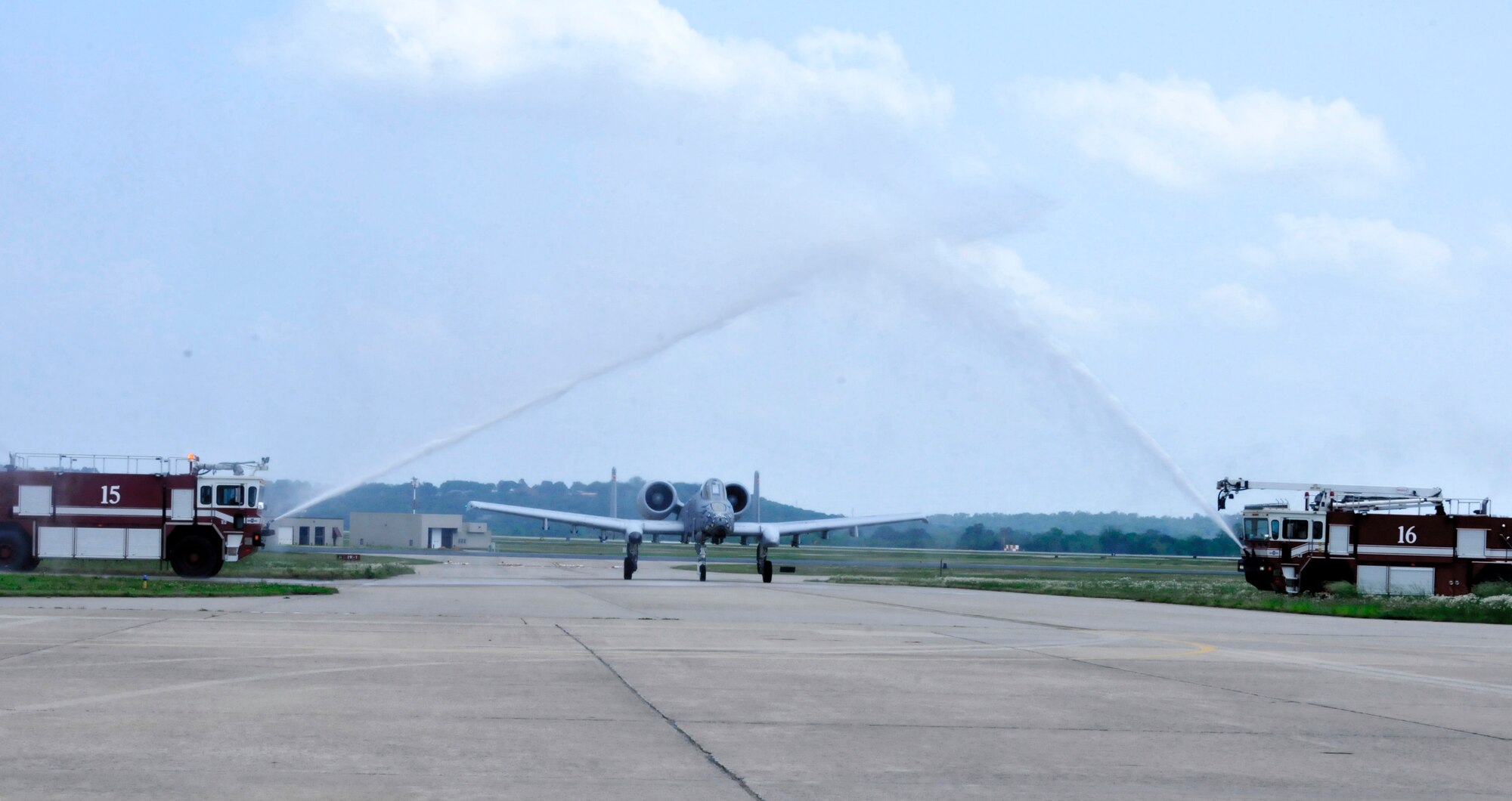 Col. Mark W. Anderson, 188th Fighter Wing commander, is sprayed with water by 188th Fire Emergency Services Flight fire trucks as he returns from his final training mission in an A-10C Thunderbolt II “Warthog”, at Ebbing Air National Guard Base, Fort Smith, Arkansas, May 12, 2014. The ceremonial "fini" flight was Anderson’s final sortie until he flies the last A-10 out of Ebbing ANG Base June 7, 2014, following the wing’s conversion ceremony. The 188th will convert from a fighter mission to a remotely piloted aircraft (MQ-9 Reapers), targeting, intelligence, surveillance and reconnaissance mission (U.S. Air National Guard photo by Tech. Sgt. Josh Lewis/released)  