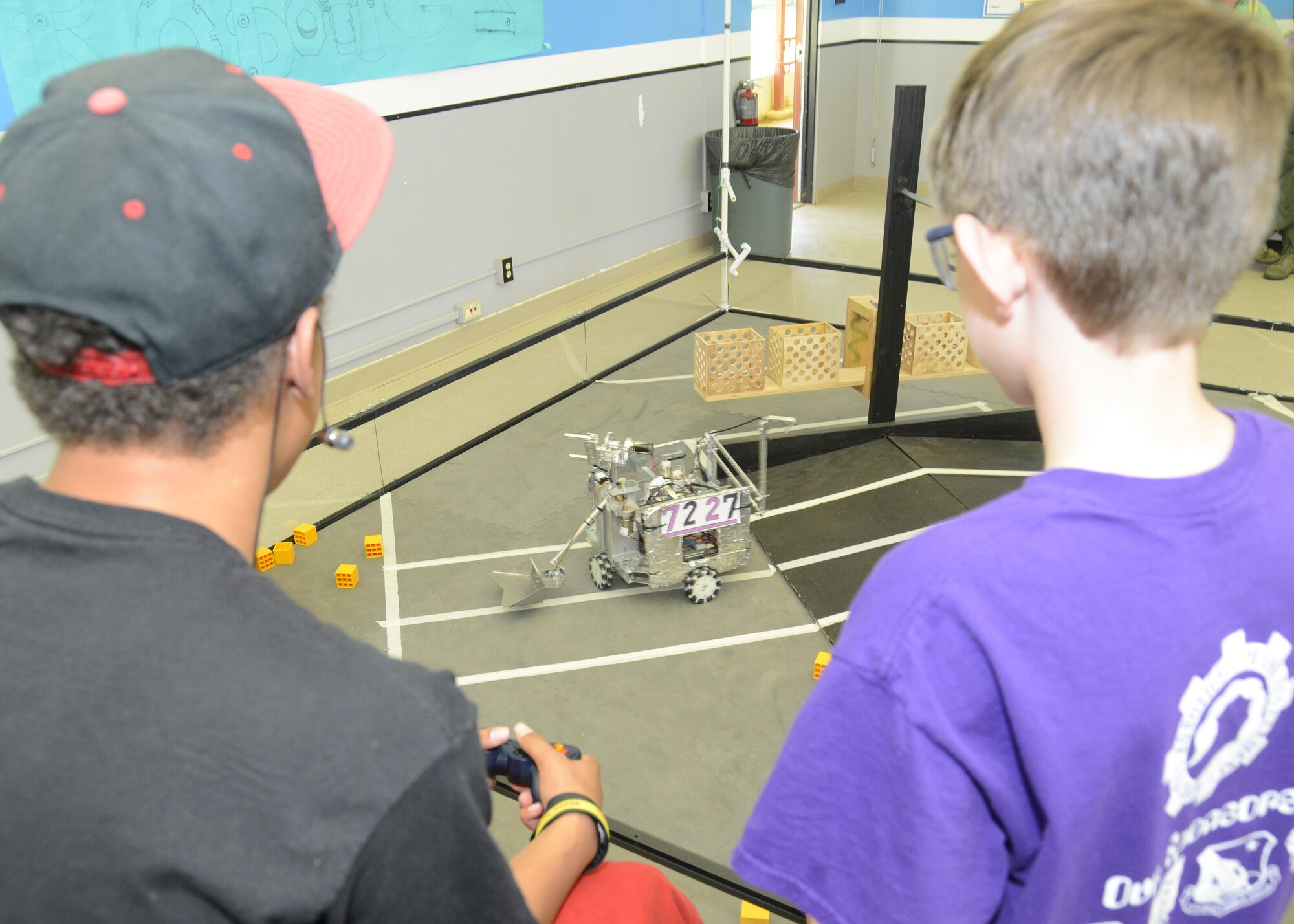 Scorpion Robotics members operate the club's Scoop Da Whoop robot at the Center of Excellence. (U.S. Air Force photo by Kenji Thuloweit) 