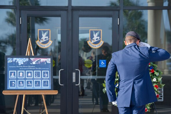 Senior Airman Joshua Serrano, 45th Security Forces Squadron, salutes a wreath after placing it on a stand during the Fallen Heroes Ceremony at Patrick Air Force Base, Fla. May 13, 2014. The ceremony honored the fallen officers who were more than just outstanding defenders; they were outstanding mothers, fathers, brothers, sisters, aunts and uncles. (U.S. Air Force photo/Matthew Jurgens) 