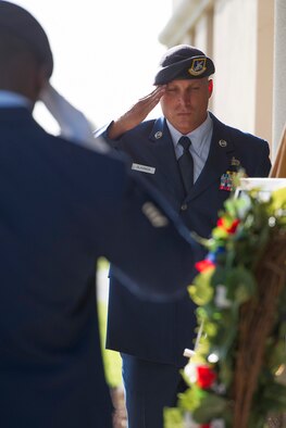 Staff Sgt. Michael Blackmon, 45th Security Forces Squadron, salutes the wreath to symbolize respect during the Fallen Heroes Ceremony at Patrick Air Force Base, Fla. May 13, 2014. Blackmon read the names of each defender while Staff Sgt. Xavier Henderson (left), rang the bell once. Each ring of the bell represents the words of President Kennedy’s proclamation in 1962. (U.S. Air Force photo/Matthew Jurgens) 