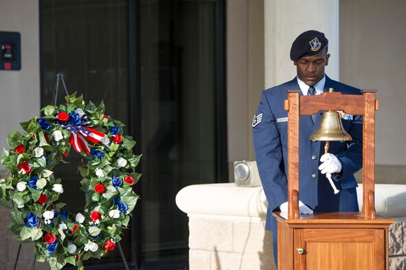Staff Sgt. Xavier Henderson, 45th Security Forces Squadron NCO in charge of supply, rings a bell during the Fallen Heroes Ceremony at Patrick Air Force Base, Fla. May 13, 2014. Henderson rang the bell once for each fallen defender and then one final ring for all who lost their life in the line of duty. The ceremony took place as part of National Police Week May 12-16. (U.S. Air Force photo/Matthew Jurgens) 