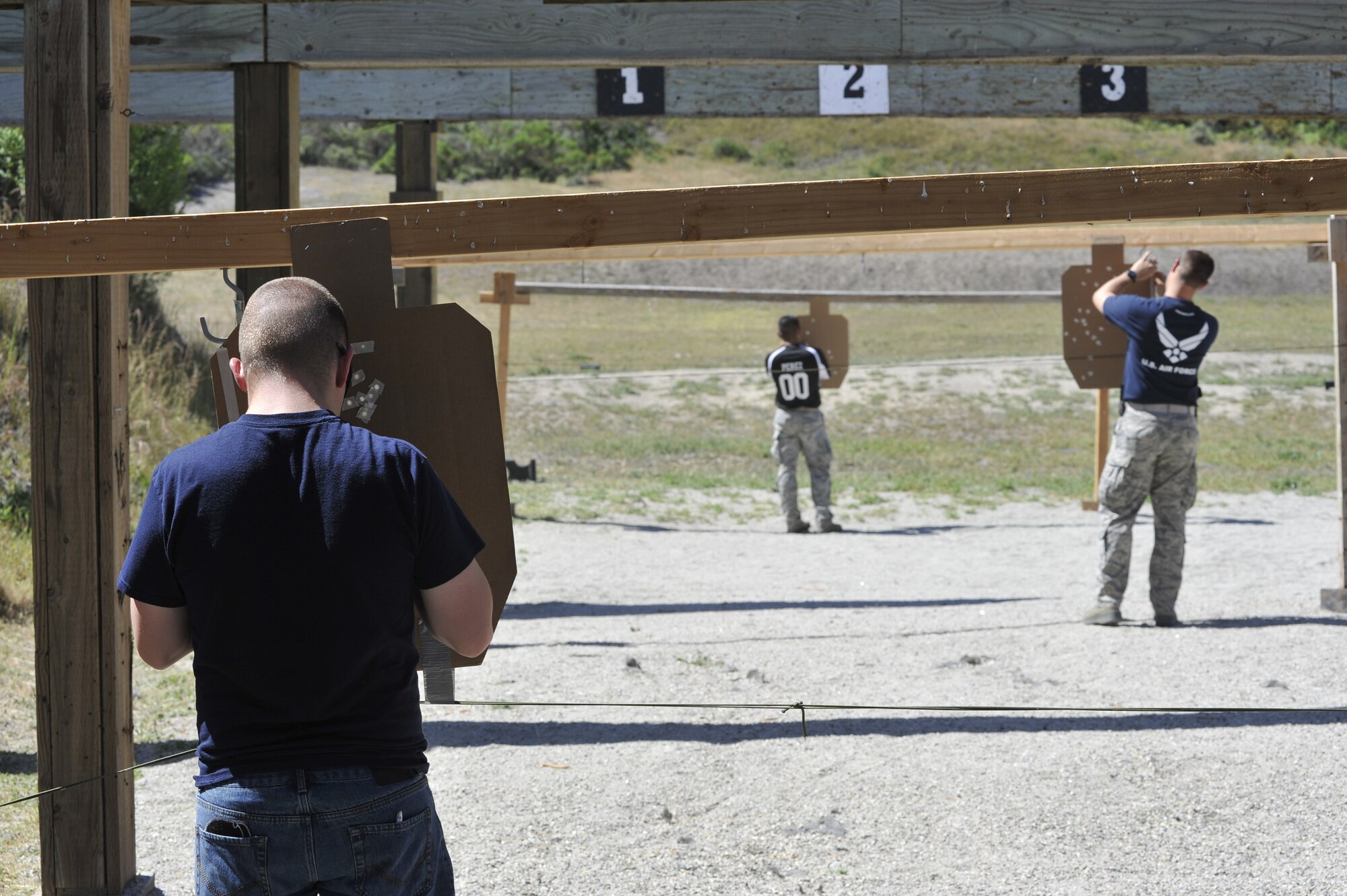 Volunteers mark bullet strikes on a group of three targets during the Law Enforcement Pistol Shoot event May 13, 2014, Vandenberg Air Force Base, Calif. The pistol shoot was open to all military and local law enforcement officers as part of a National Police Week celebration at Vandenberg. (U.S. Air Force photo by Michael Peterson/Released)