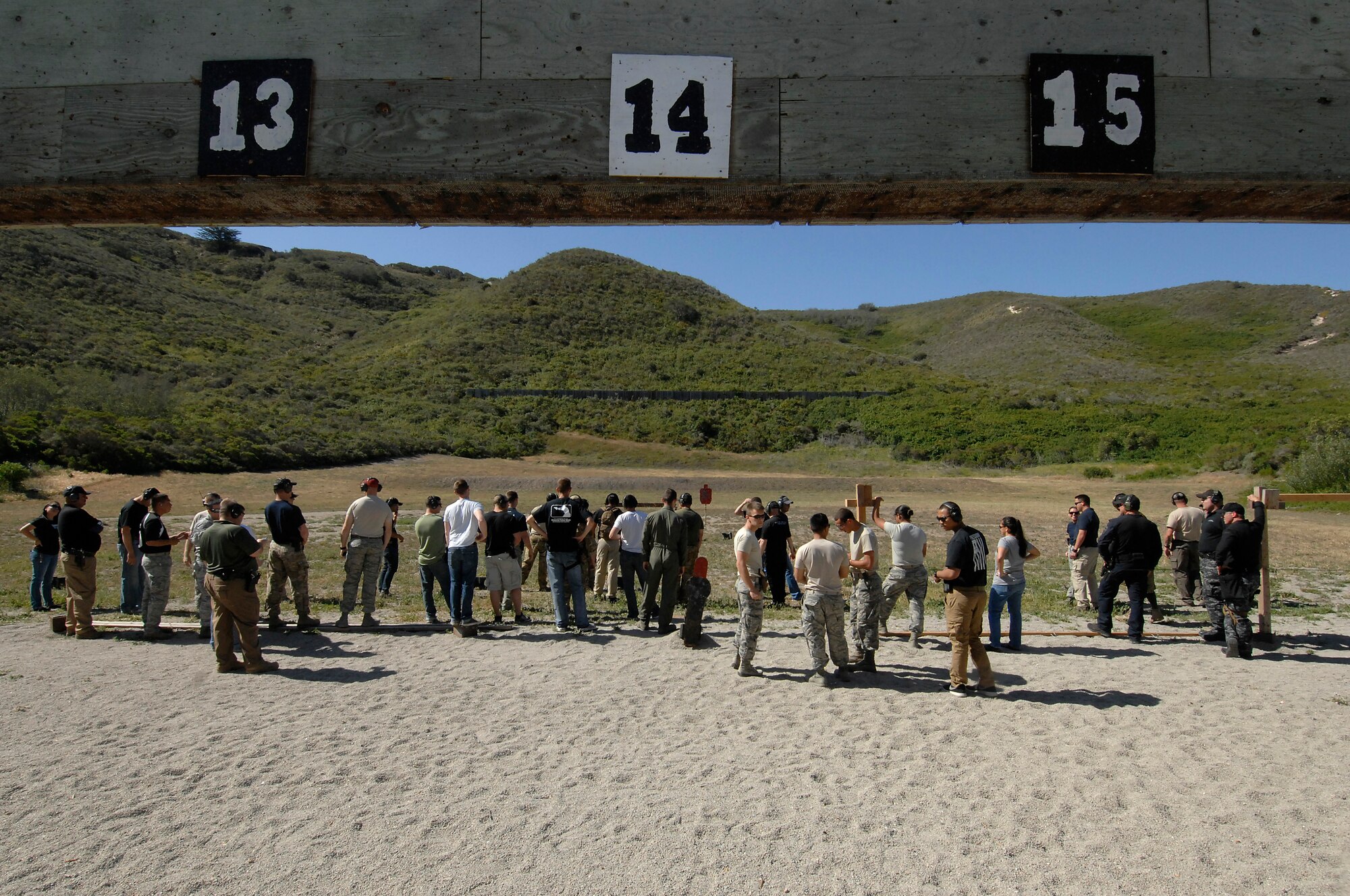 Competitors gather at the shooting range for the first round of a shooting challenge during the Law Enforcement Pistol Shoot event, May 13, 2014, Vandenberg Air Force base, Calif. The pistol shoot was open to all military and local law enforcement officers as part of a National Police Week celebration at Vandenberg. (U.S. Air Force photo by Michael Peterson/Released)
