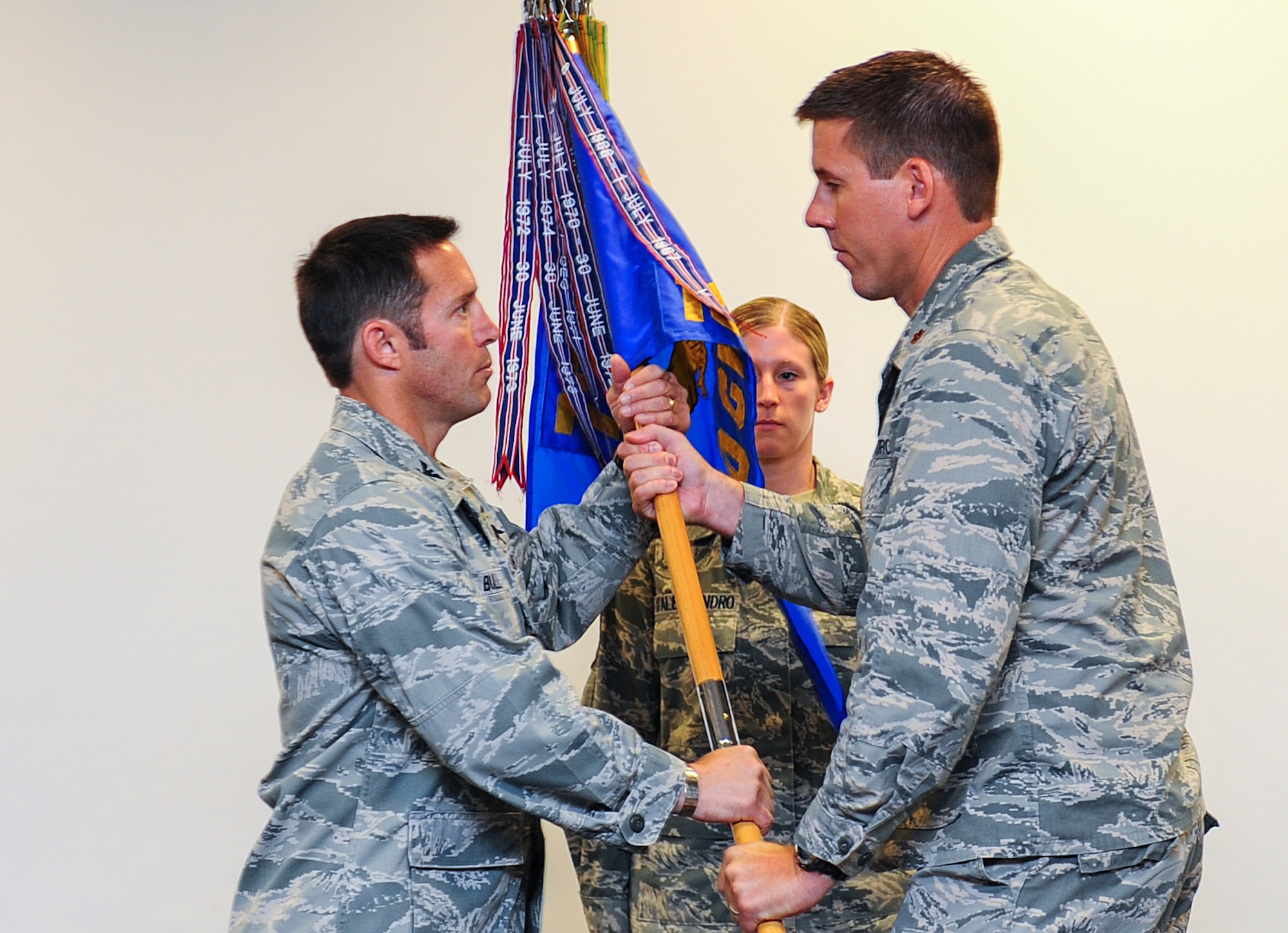 Maj. William Schroeder, 10th Combat Weather Squadron former commander, passes the guideon to Col. Kurt Buller, 720th Special Tactics Group commander, during the 10th CWS deactivation ceremony at Hurlburt Field, Fla., May 7, 2014. The 10th CWS Airmen will be integrated into special tactics squadrons within the 24th Special Operations Wing. (U.S. Air Force photo/Airman 1st Class Jeff Parkinson)