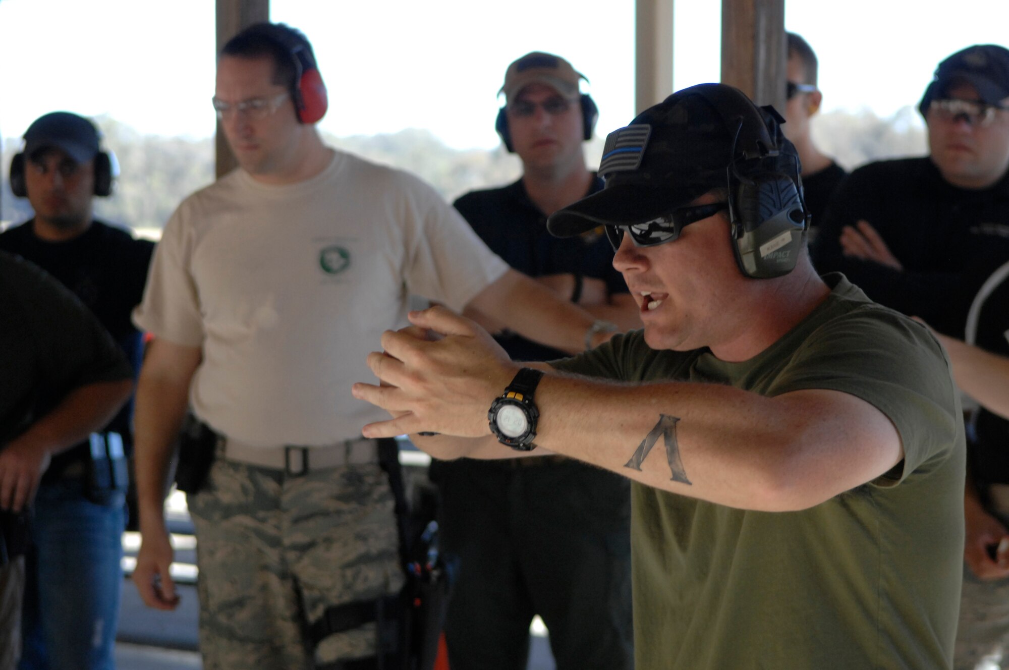 Staff Sgt. Daniel Kane, 30th Security Forces Squadron patrolman, begins his walkthrough demonstration of the timed shooting course during the Law Enforcement Pistol Shoot event May 13, 2014, Vandenberg Air Force Base, Calif. The pistol shoot was open to all military and local law enforcement officers as part of a National Police Week celebration at Vandenberg. (U.S. Air Force photo by Michael Peterson/Released)

