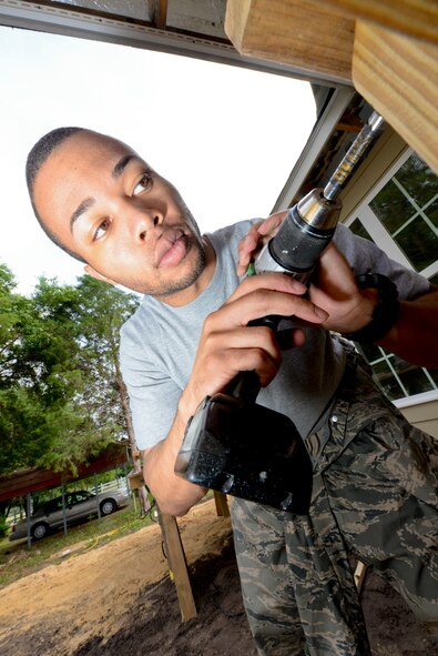 U.S Air Force Staff Sgt. Christopher Carter, 23d Aerospace Medical Squadron, builds a porch railing during a Habitat for Humanity build in Ray City, Ga., May 10, 2014. Carter and fellow Moody Airmen helped build various parts of the house which will go to a low-income family in the local community. (U.S. Air Force photo by Tech. Sgt. Joshua J. Garcia ) 