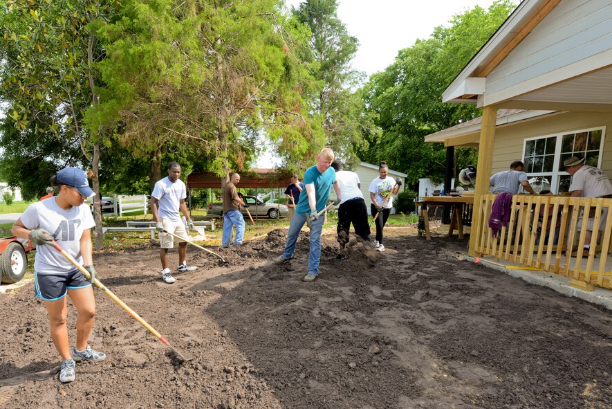 Airmen from Moody Air Force Base, Ga., even out dirt during a Habitat for Humanity build in Ray City, Ga., May 10, 2014. Over 20 volunteers from Moody worked alongside construction workers for Habitat for Humanity during the build. Moody Airmen volunteer for Habitat for Humanity monthly, helping low-income families in the local community. (U.S. Air Force photo by Tech. Sgt. Joshua J. Garcia/Released) 
