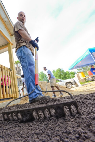 U.S. Air Force Tech. Sgt. Obed Brown, 23d Maintenance Group, evens out dirt during a habitat for humanity build in Ray City, Ga., May 10, 2014. The dirt was spread out around the three bedroom house to create the foundation for the house’s yard. (U.S. Air Force photo by Tech. Sgt. Joshua J. Garcia/Released) 