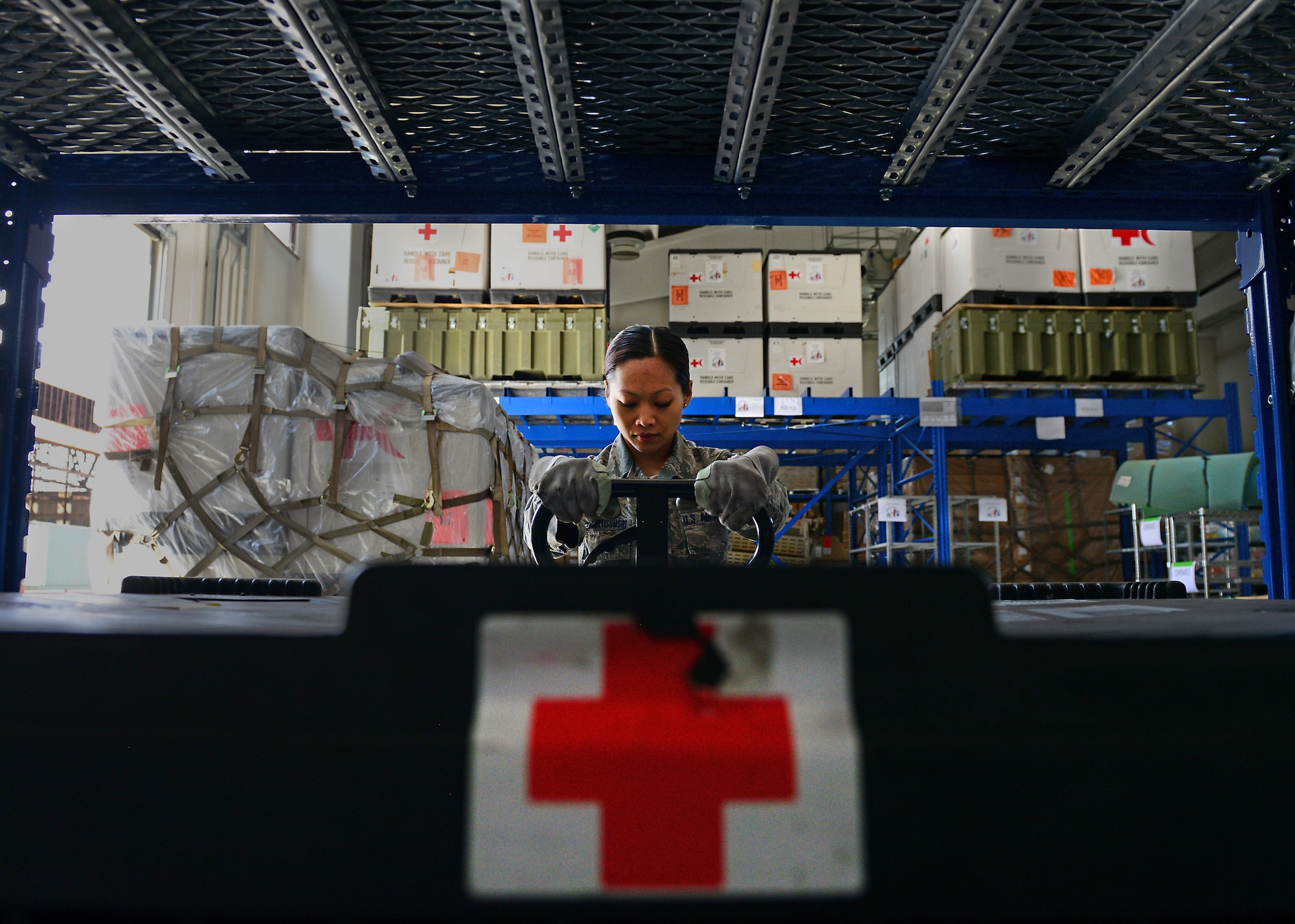 Staff Sgt. Prapaporn Wangsuttisomsri, 31st Medical Support Squadron medical logistics technician, pulls out a pallet of medical supplies from the war reserve material warehouse, May 12, 2014, at Aviano Air Base, Italy. The responsibility of stocking, preparing and shipping more than $6 million worth of equipment and supplies falls upon medical logistics Airmen tasked with the preservation of medical supplies that could one day save a life. (U.S. Air Force photo/Airman 1st Class Ryan Conroy)    