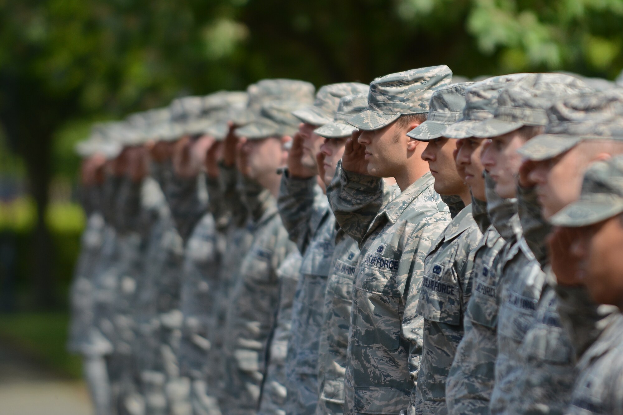 Team Mildenhall Airmen salute the U.S. flag as it is lowered during a retreat ceremony for Honorary Commanders’ Day May 13, 2014, on RAF Mildenhall, England. Honorary Commanders’ Day is a program dedicated to linking local community leaders with military leaders to bolster community relations. (U.S. Air Force photo by Senior Airman Micaiah Anthony/Released)