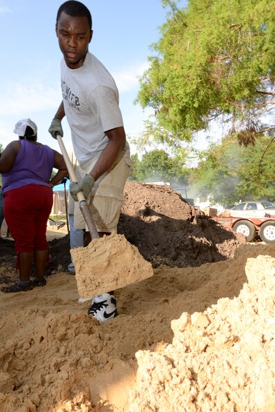 Airman 1st Class Braden Anderson, 23d Wing Public Affairs, shovels dirt from a mound during a Habitat for Humanity build in Ray City, Ga., May 10, 2014. The dirt was spread with a five percent decline to ensure the house would not be flooded during rainy seasons. (U.S. Air Force photo by Tech Sgt. Joshua J. Garcia/Released) 