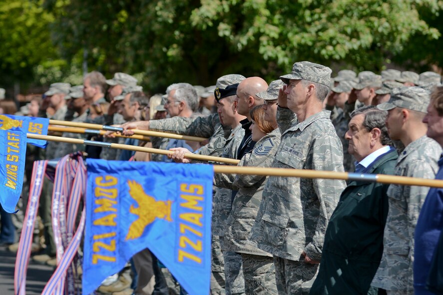Members of Team Mildenhall and local community leaders pay respect to the U.S. flag and Royal Air Force ensign during a retreat ceremony for Honorary Commanders’ Day May 13, 2014, on RAF Mildenhall, England. Honorary commanders paired with their respective military equivalents to develop a professional network to strengthen community relations both on and off base. (U.S. Air Force photo by Senior Airman Micaiah Anthony/Released)