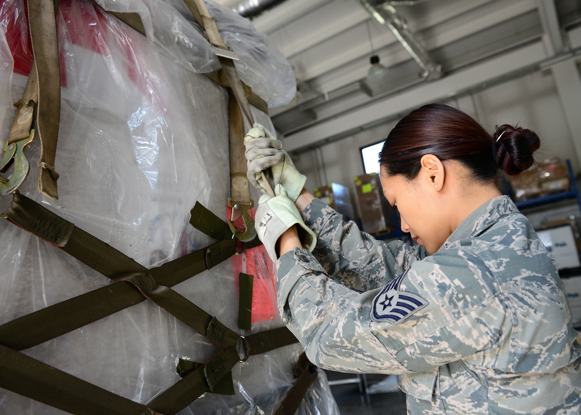 Staff Sgt. Prapaporn Wangsuttisomsri, 31st Medical Support Squadron medical logistics technician, pulls a ratchet strap tight on a pallet of medical supplies, May 12, 2014, at Aviano Air Base, Italy. The pallets are organized by priority and the first ones unloaded in a deployed area of responsibility contain the essentials for the emergency room and surgical setup. (U.S. Air Force photo/Airman 1st Class Ryan Conroy) 