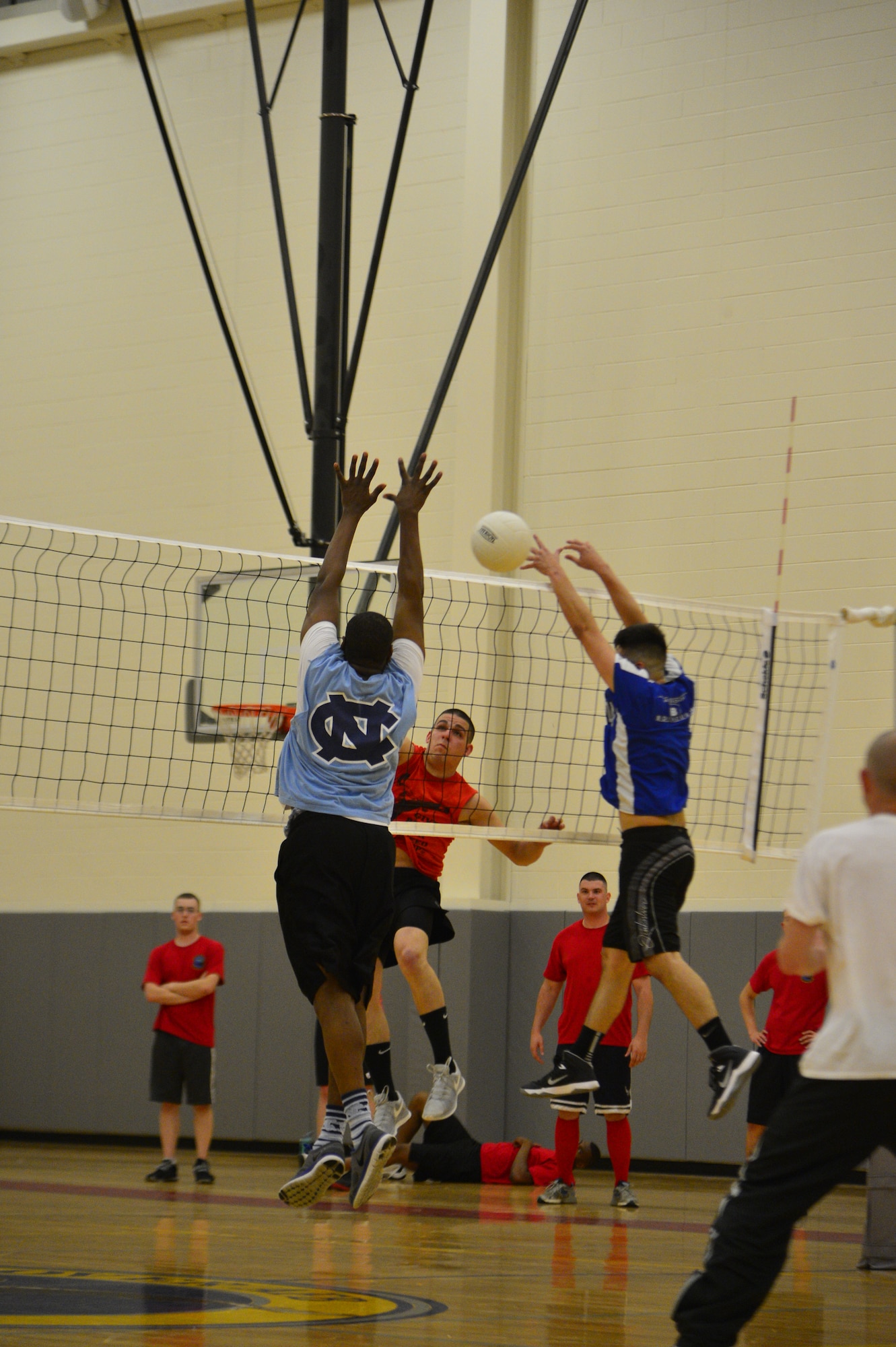 Antonio Chaviano, 436th Logistics Readiness Squadron volleyball team, spikes a volleyball past two defenders during an intramural volleyball game May 13, 2014, at the fitness center on Dover Air Force Base, Del. LRS defeated the 436th/736th Aircraft Maintenance Squadron 25-19 and 25-12. (U.S. Air Force photo/Airman 1st Class Zachary Cacicia)
