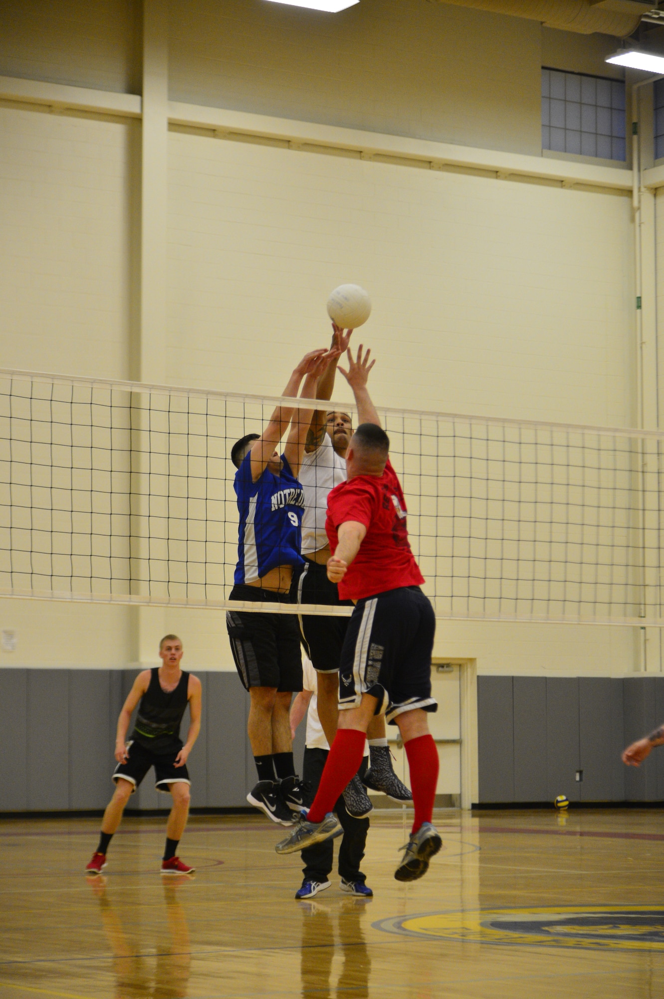 Benjamin Sperring, 436th Logistics Readiness Squadron volleyball team, attempts to poke a ball past two defenders during an intramural volleyball game May 13, 2014, at the fitness center on Dover Air Force Base, Del. LRS, who had previously lost to the combined 436th/736th Aircraft Maintenance Squadron team, avenged their only loss of the season. (U.S. Air Force photo/Airman 1st Class Zachary Cacicia)