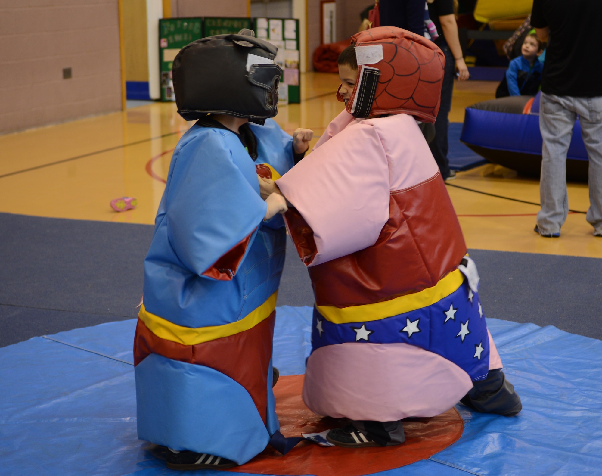 Team Mildenhall children sumo wrestle May 10, 2014, during a spring fun day at the youth center on RAF Mildenhall, England. Multiple events were set up for children, including bouncy castles, an obstacle course, a dunk tank and pedal car races. (U.S. Air Force photo by Airman 1st Class Dillon Johnston/Released)