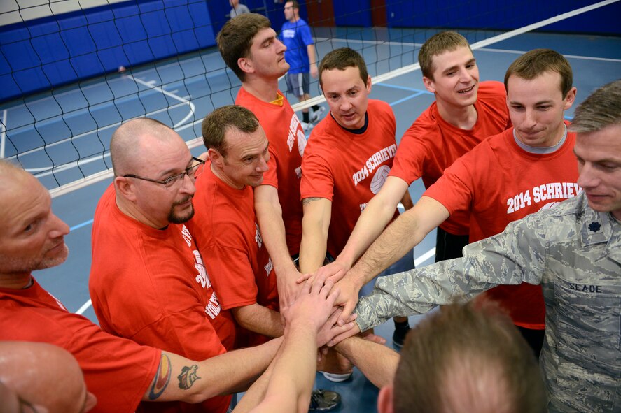 Members of the 2nd Space Operations Squadron celebrate after winning the base intramural volleyball finals May 8, 2014, at Schriever Air Force Base, Colo. The 2 SOPS team beat the U.S. Air Force Warfare Center-A to win the championship game. (U.S. Air Force photo/Christopher DeWitt)